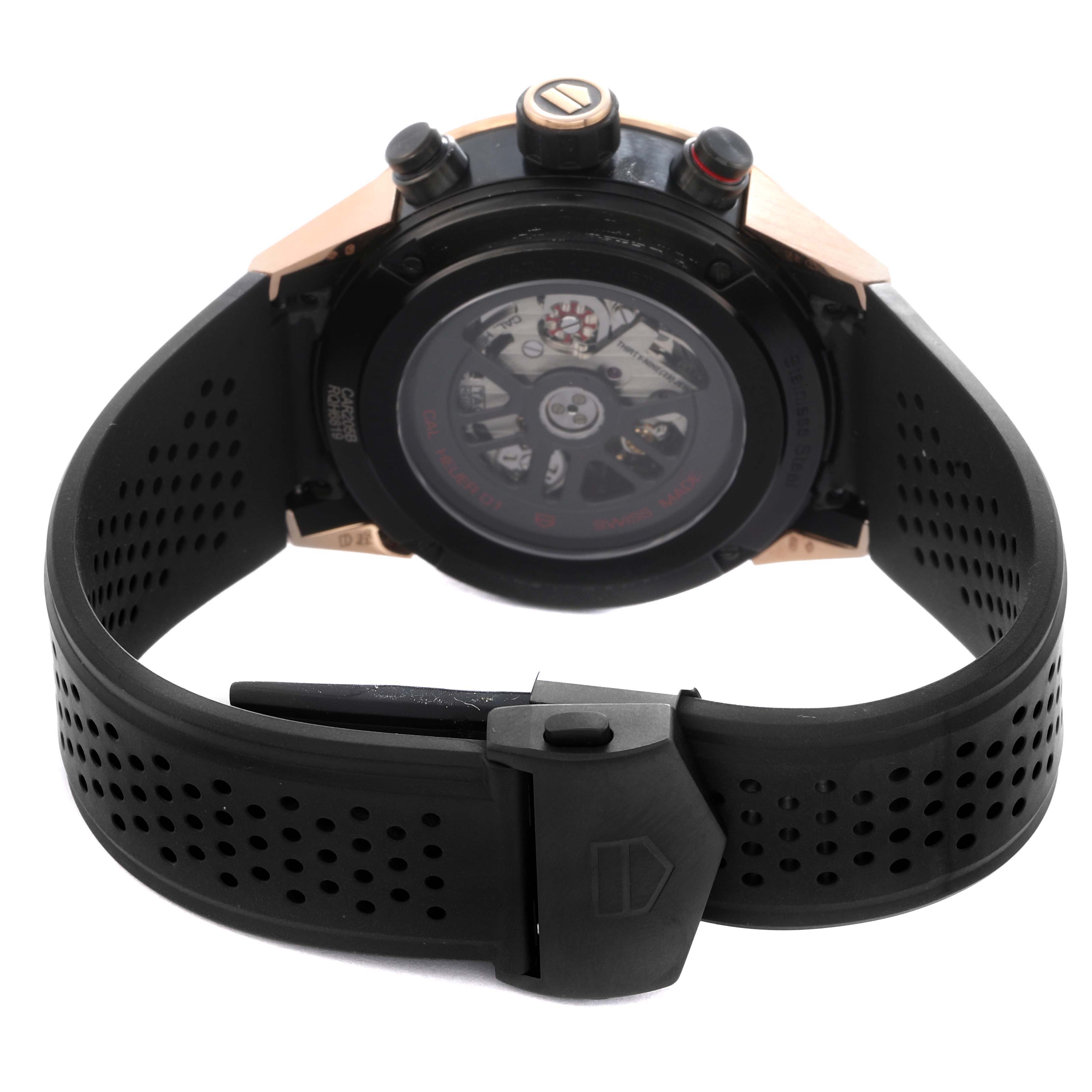The image shows the back view of the Tag Heuer Carrera model CAR205B men's watch, highlighting its case back and perforated black strap.