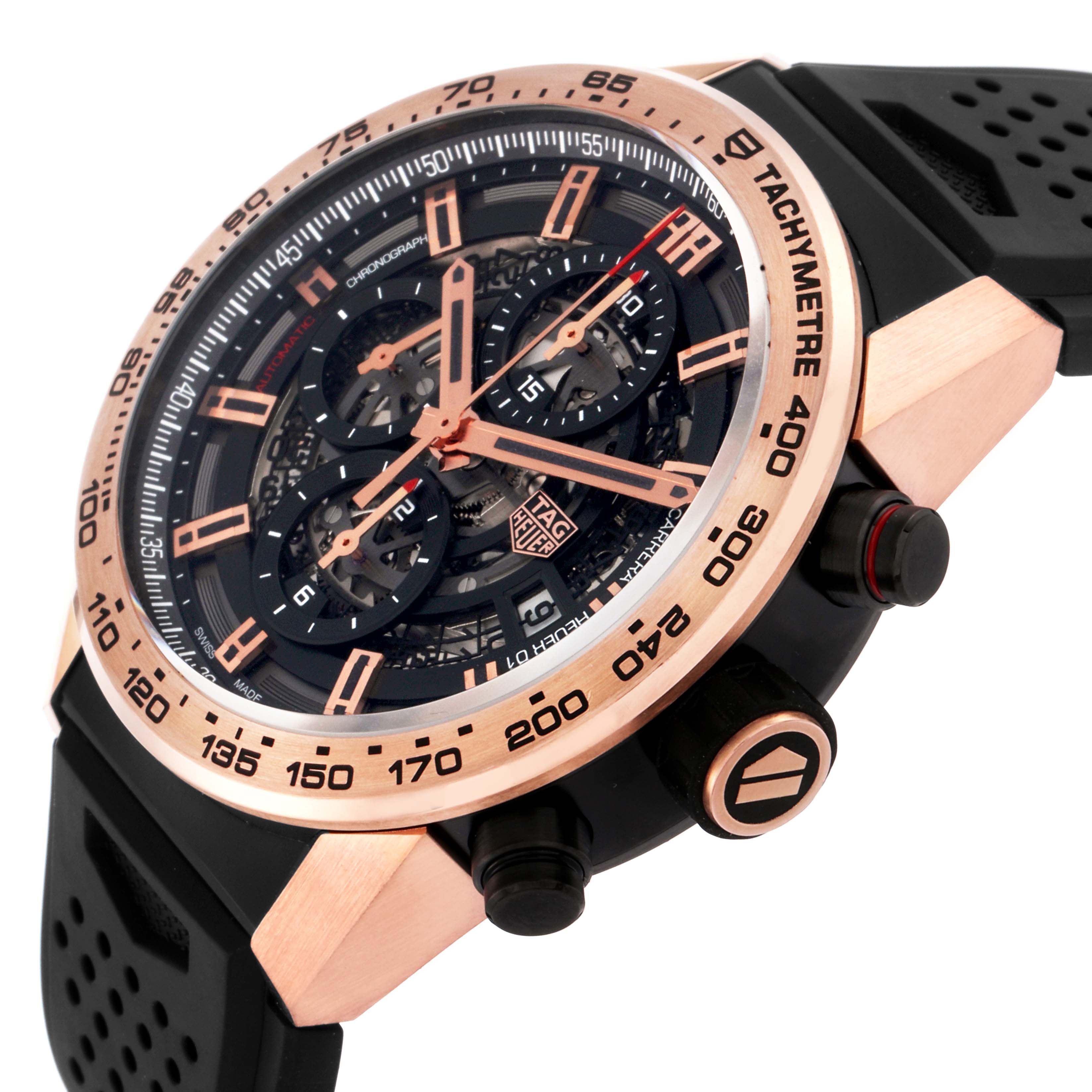 The image shows a Tag Heuer Carrera model CAR205B men's watch at a three-quarter angle, highlighting the rose gold bezel, tachymeter, black dial, and strap.
