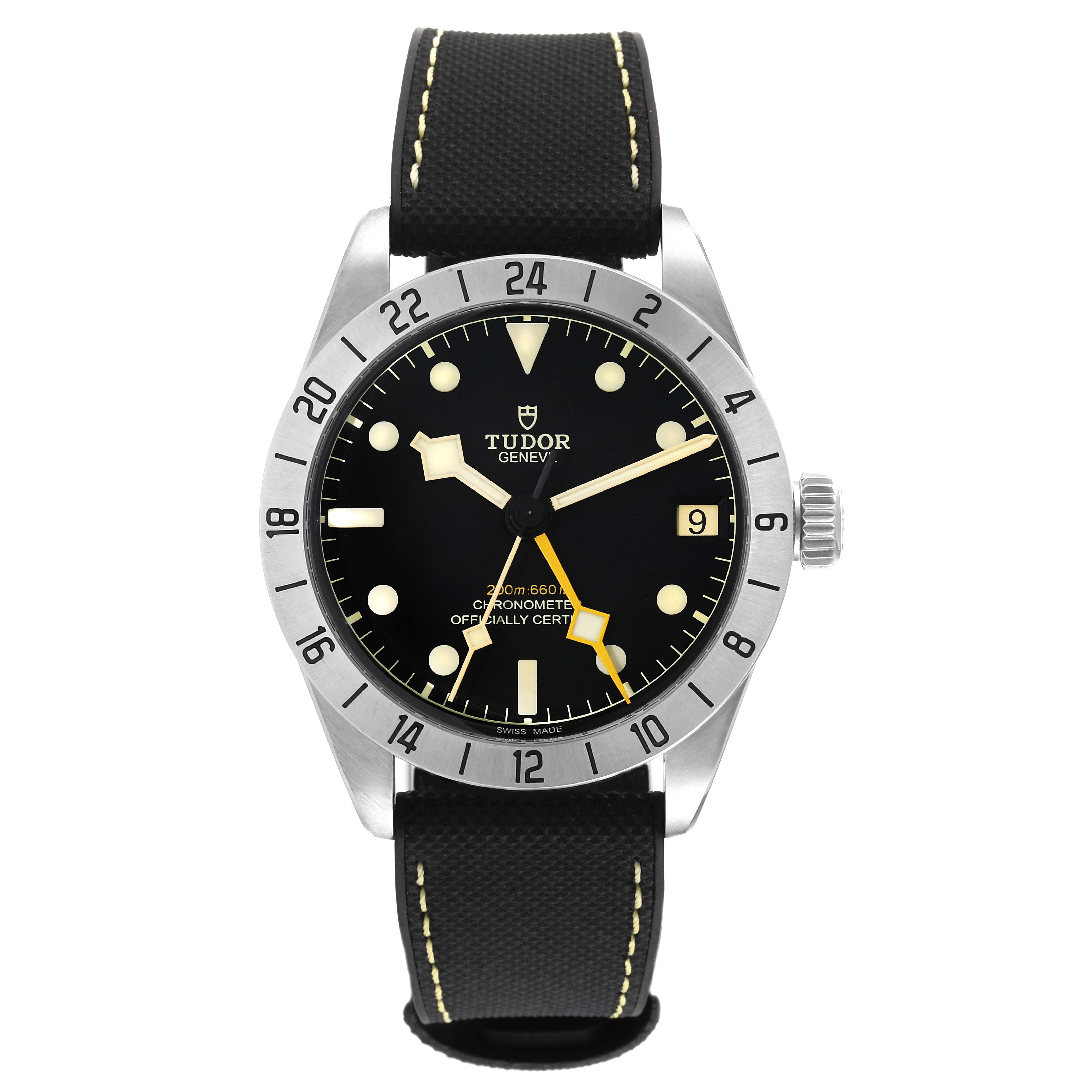 The image shows a front angle of the Tudor Heritage Black Bay 79470 Men
s Stainless Steel Black Dial 79470 Men
s Stainless Steel Black Dial watch, featuring its black dial, stainless steel case, and fabric strap.