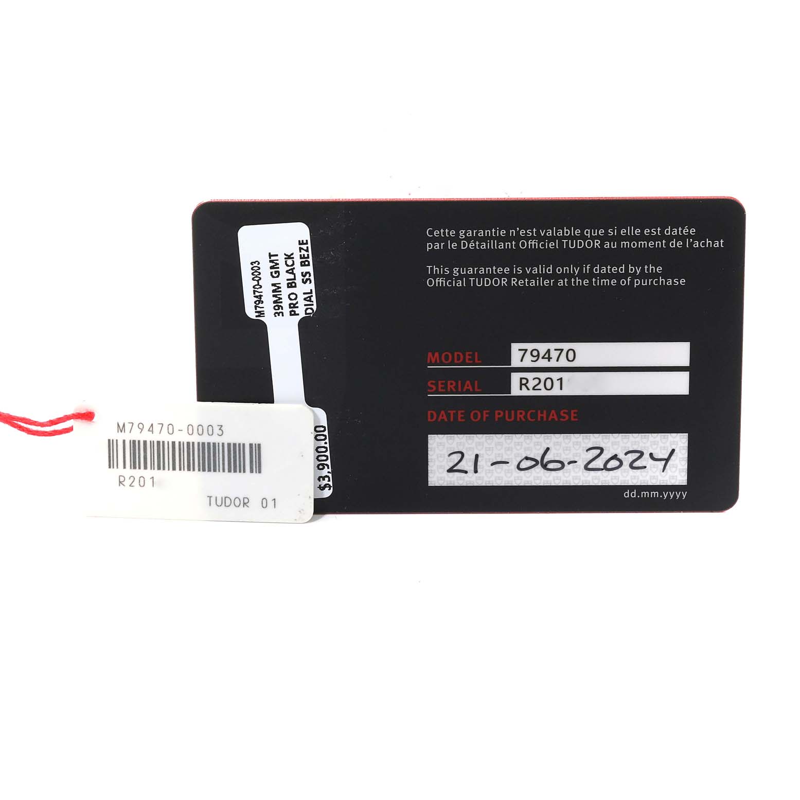 This image shows the warranty and price tags for a Tudor Heritage Black Bay 79470 Men
s Stainless Steel Black Dial 79470 Men
s Stainless Steel Black Dial model 79470 watch, displaying the serial number and purchase date.