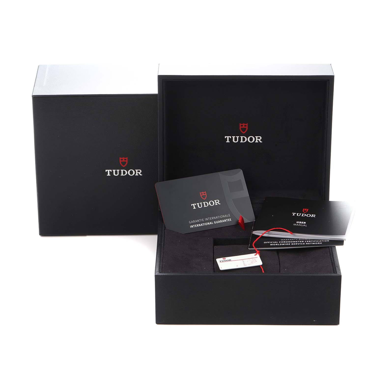 The image shows the packaging and accessories for a Tudor Heritage Black Bay model 79230R, including the box, warranty card, and user manual.