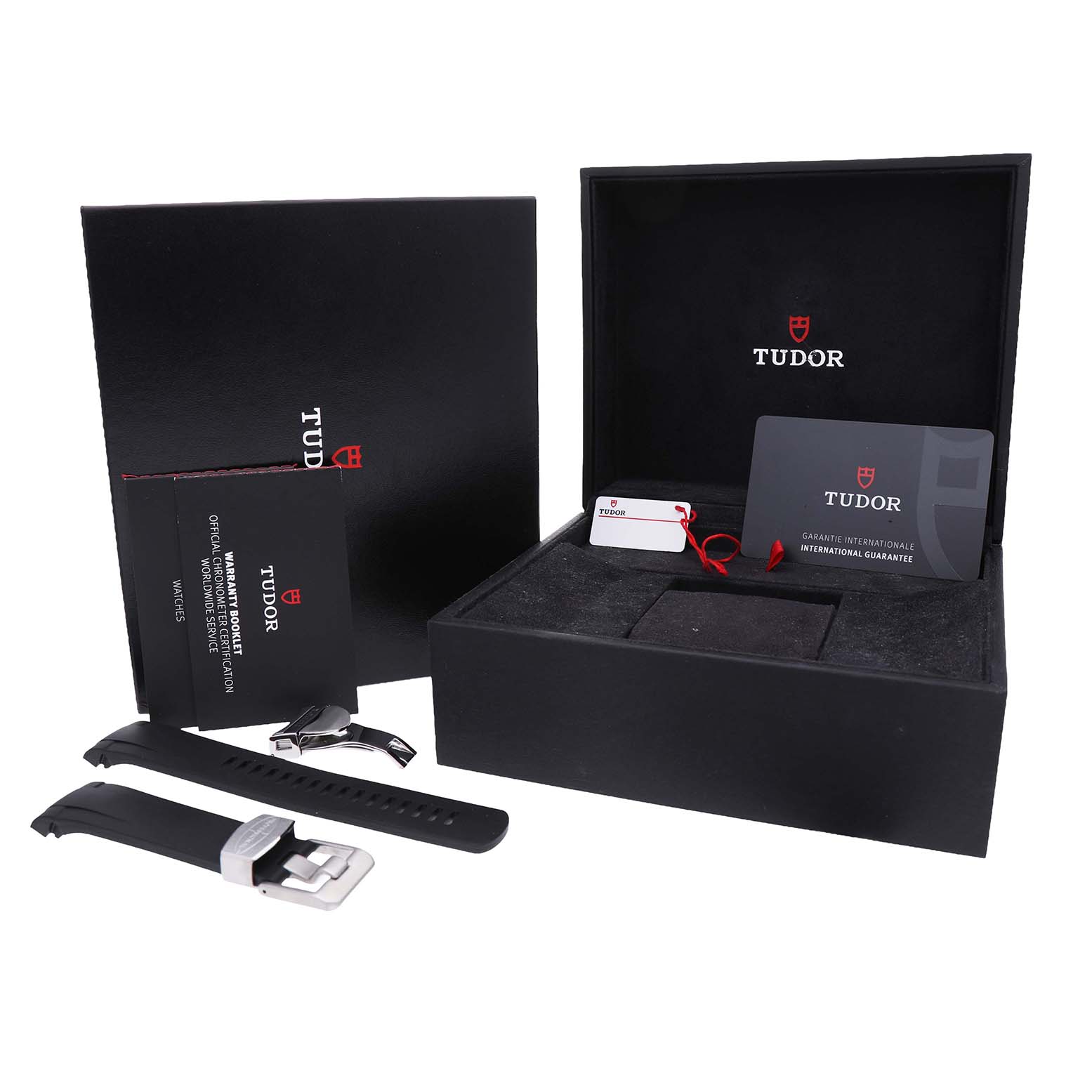 The image shows the Tudor Heritage Black Bay M79730-003 Men's Stainless Steel Black Dial box, extra strap, clasp, and warranty card from a frontal angle.