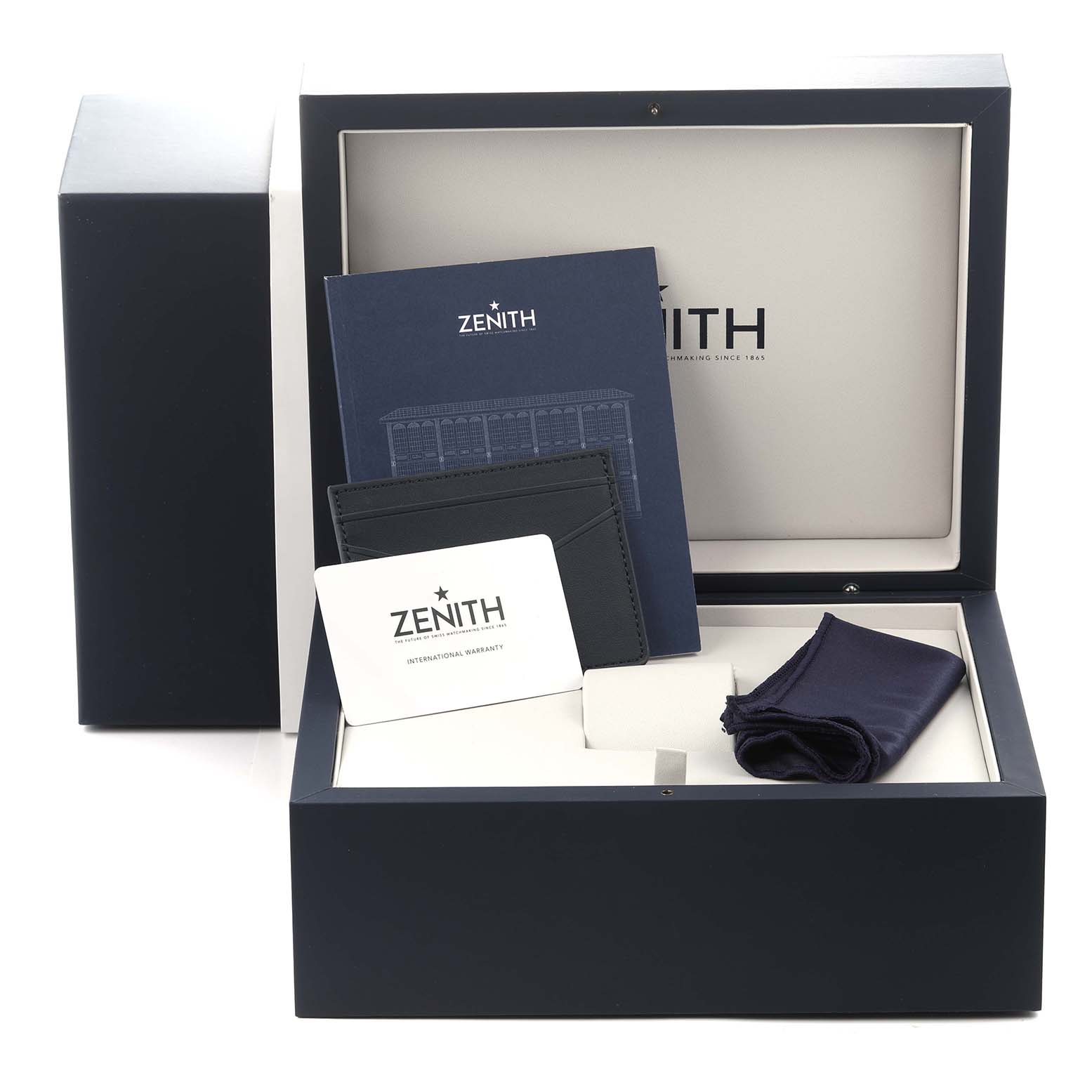The image shows the packaging and accessories for the Zenith Chronomaster model 03.3100.3600/21.M3100, including the box, warranty card, booklet, and cloth.