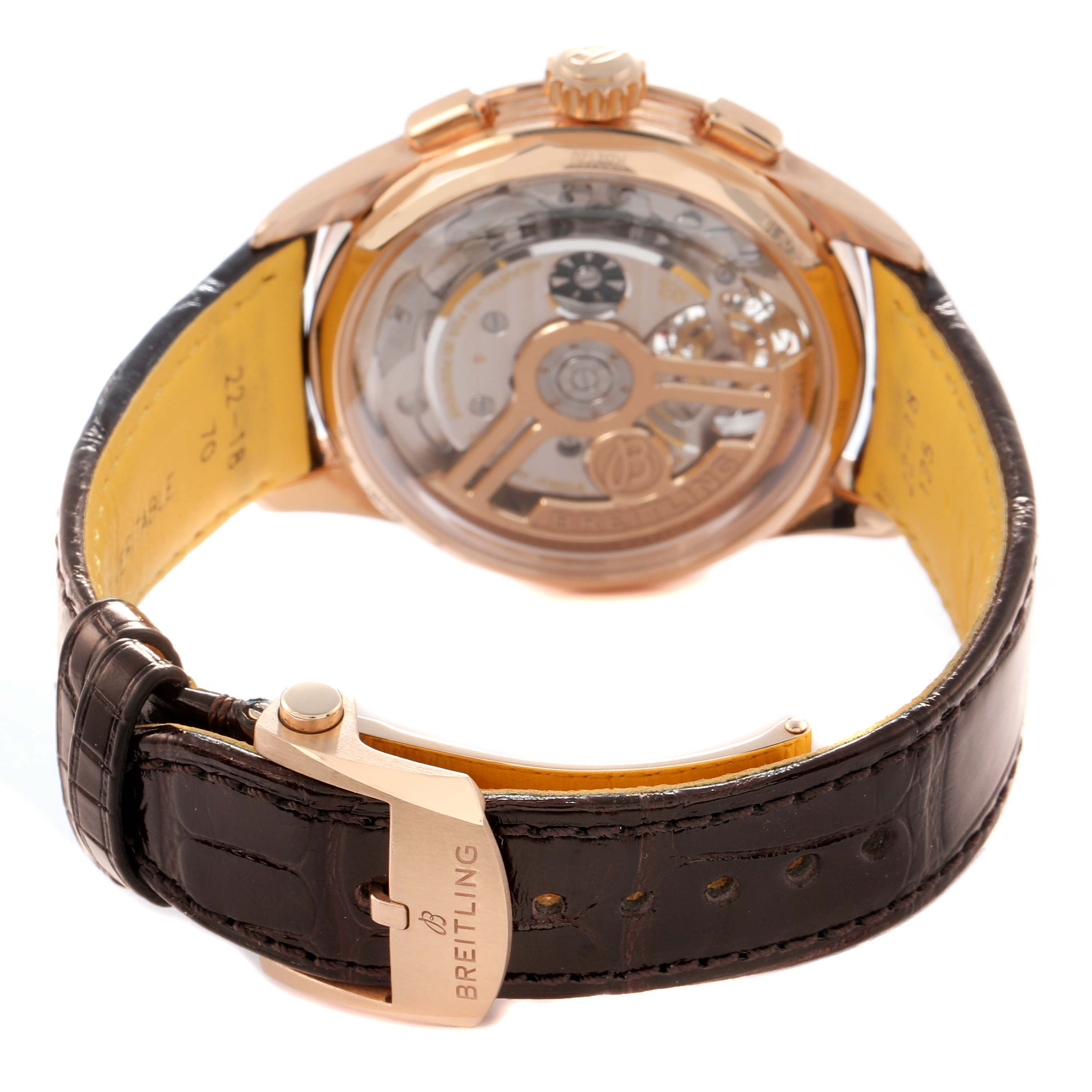 The image shows the back of the Breitling Premier model RB21202A1K1P1, highlighting the movement and leather strap with the clasp visible.