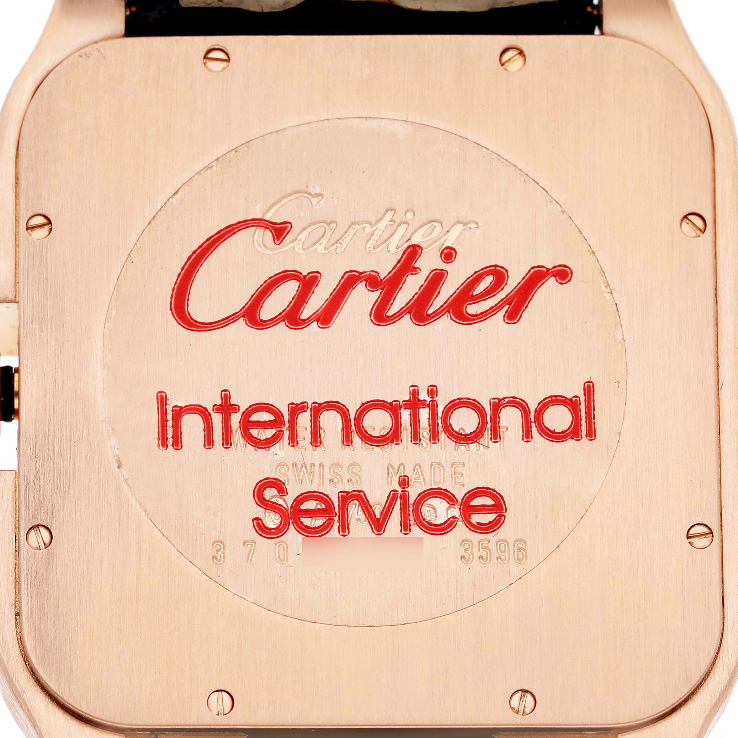 This image shows the case back of a Cartier Santos Dumont W2020068 Men's Rose Gold Grey Dial watch, featuring engraved branding and service information.