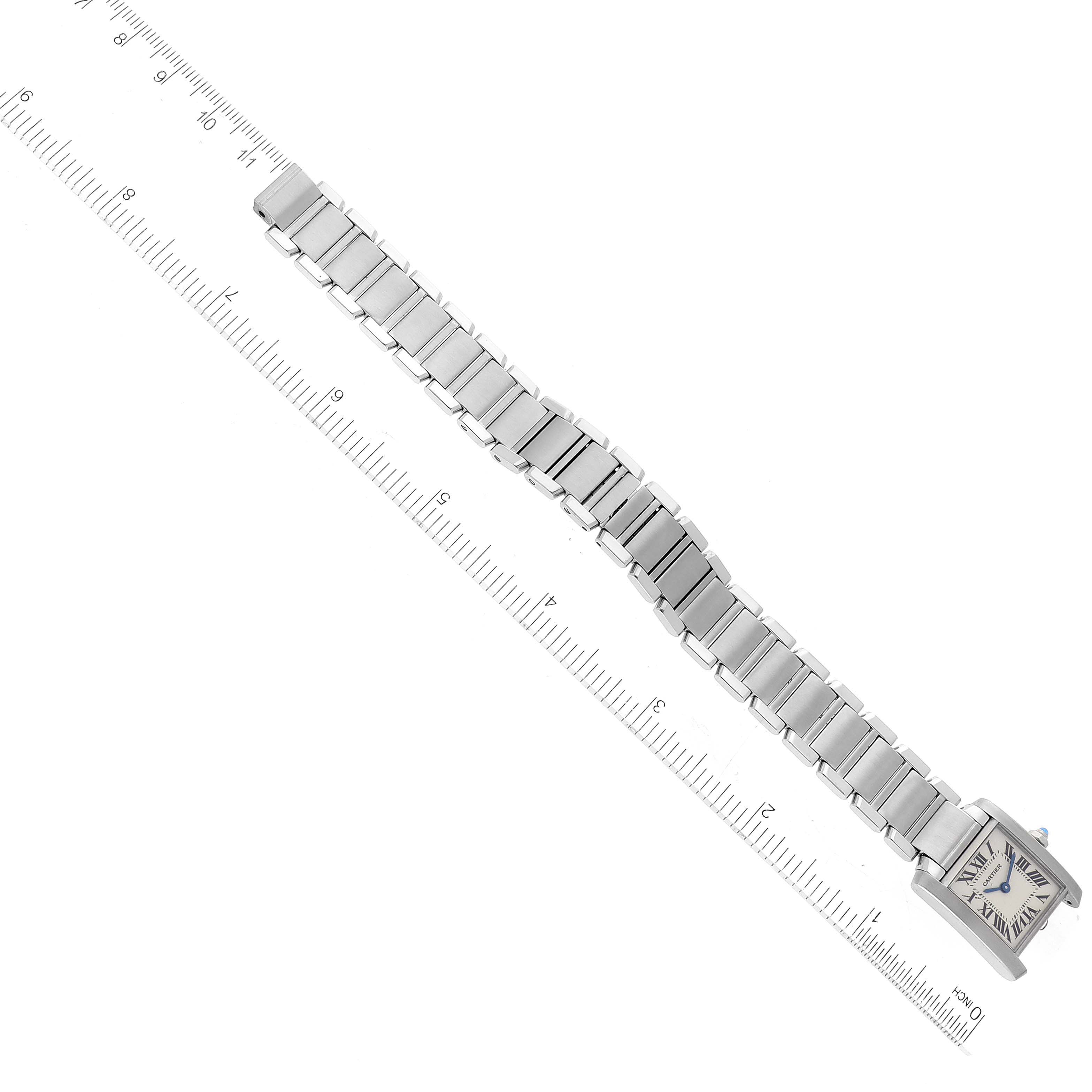 The image shows the Tank Francaise watch by Cartier, displaying its entire metal bracelet and square watch face next to a ruler for scale.