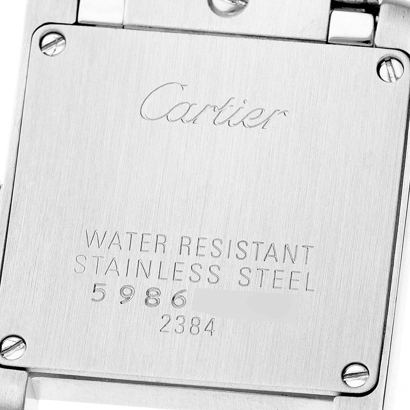 The image shows the back case of a Cartier Tank Francaise W51027Q4 Women's Steel and Gold (two tone) Mother of Pearl Dial watch, featuring engraved details and screws.