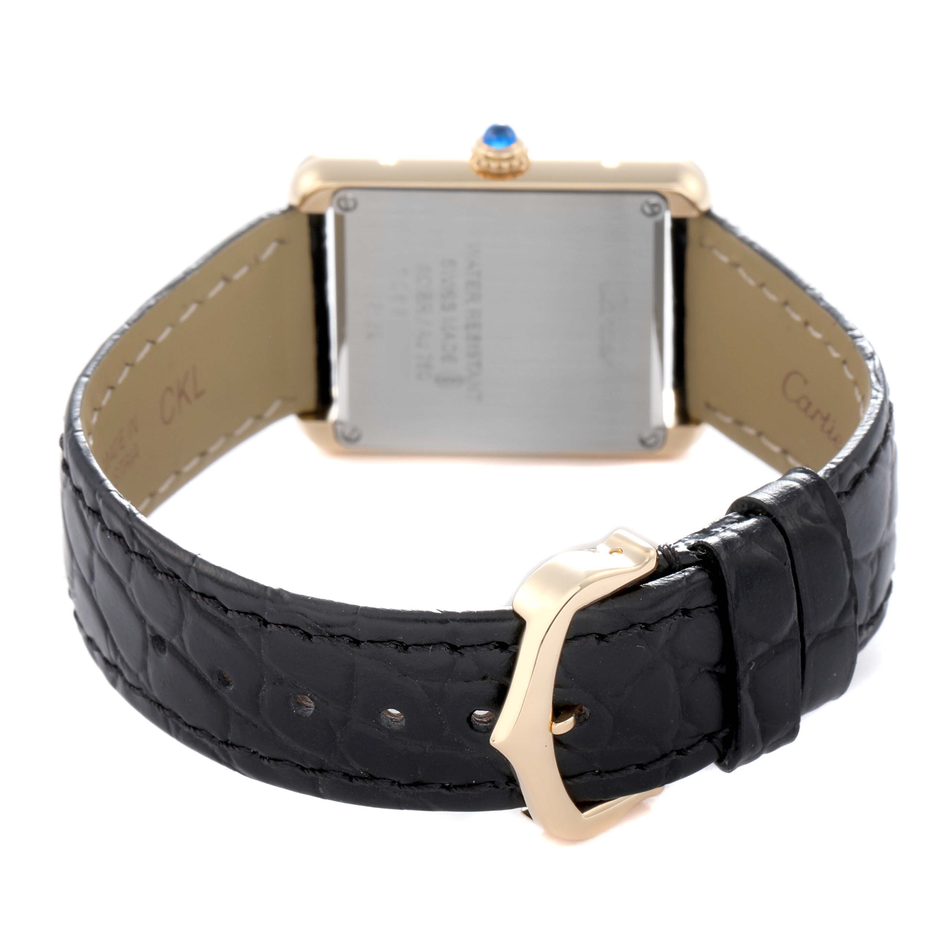 The image shows the back view of a Cartier Tank Solo model W5200002 men's watch, highlighting the clasp, leather strap, and stainless steel case back.