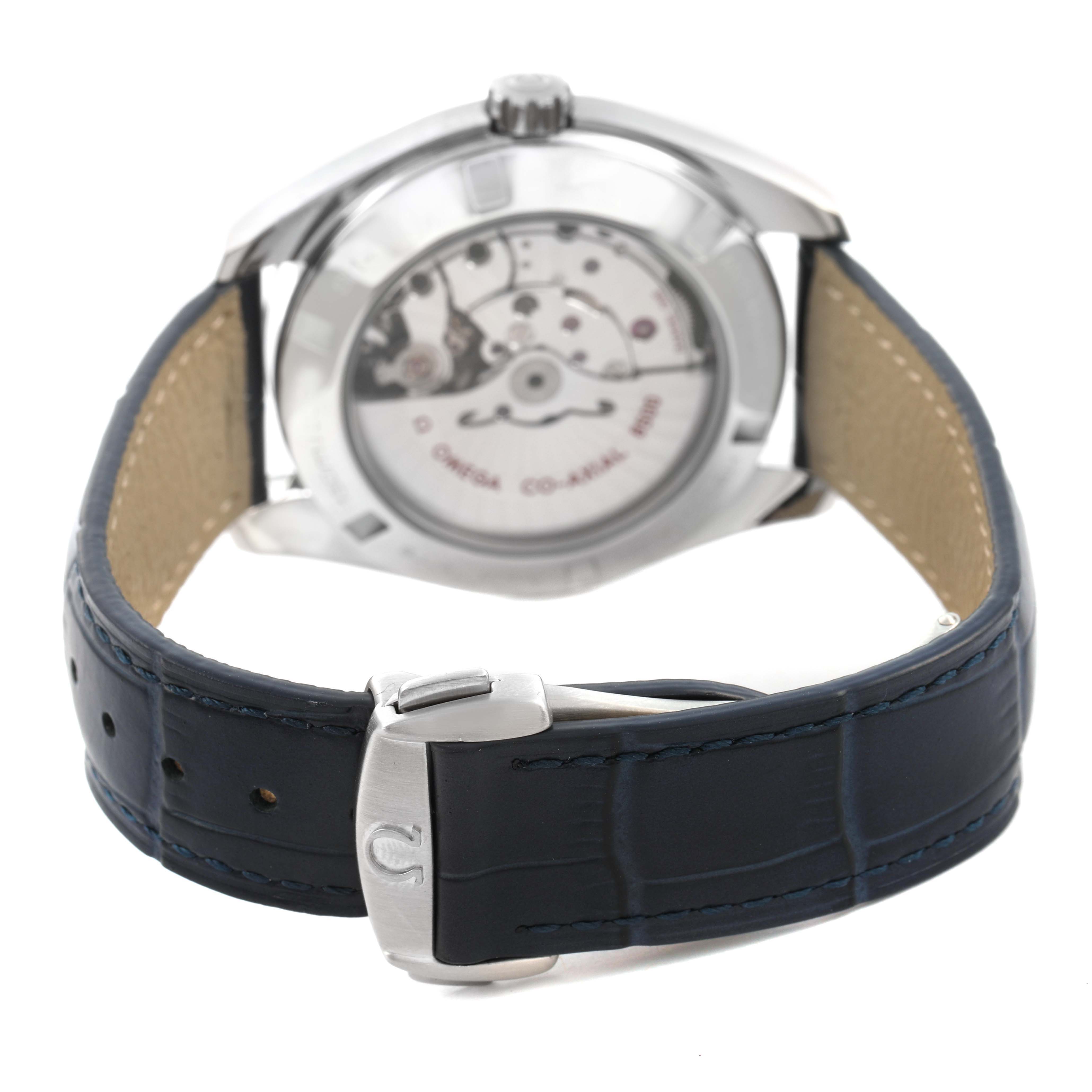 The Omega Aqua Terra 231.13.42.21.03.001 Men's Stainless Steel Blue Dial watch is shown from the back, highlighting the open caseback and blue strap with clasp.