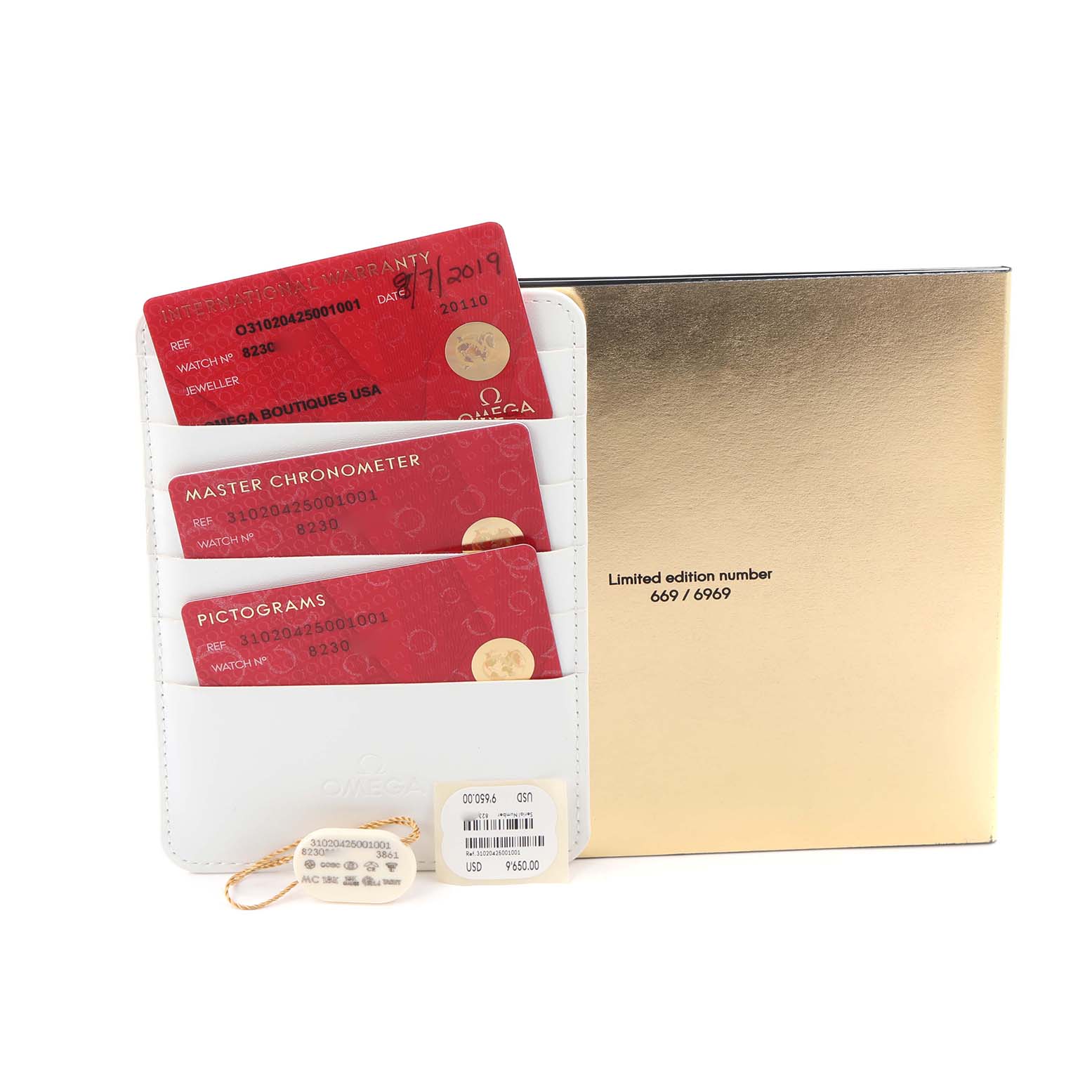 The image shows the warranty cards and a limited edition box for the Omega Speedmaster model 310.20.42.50.01.001.