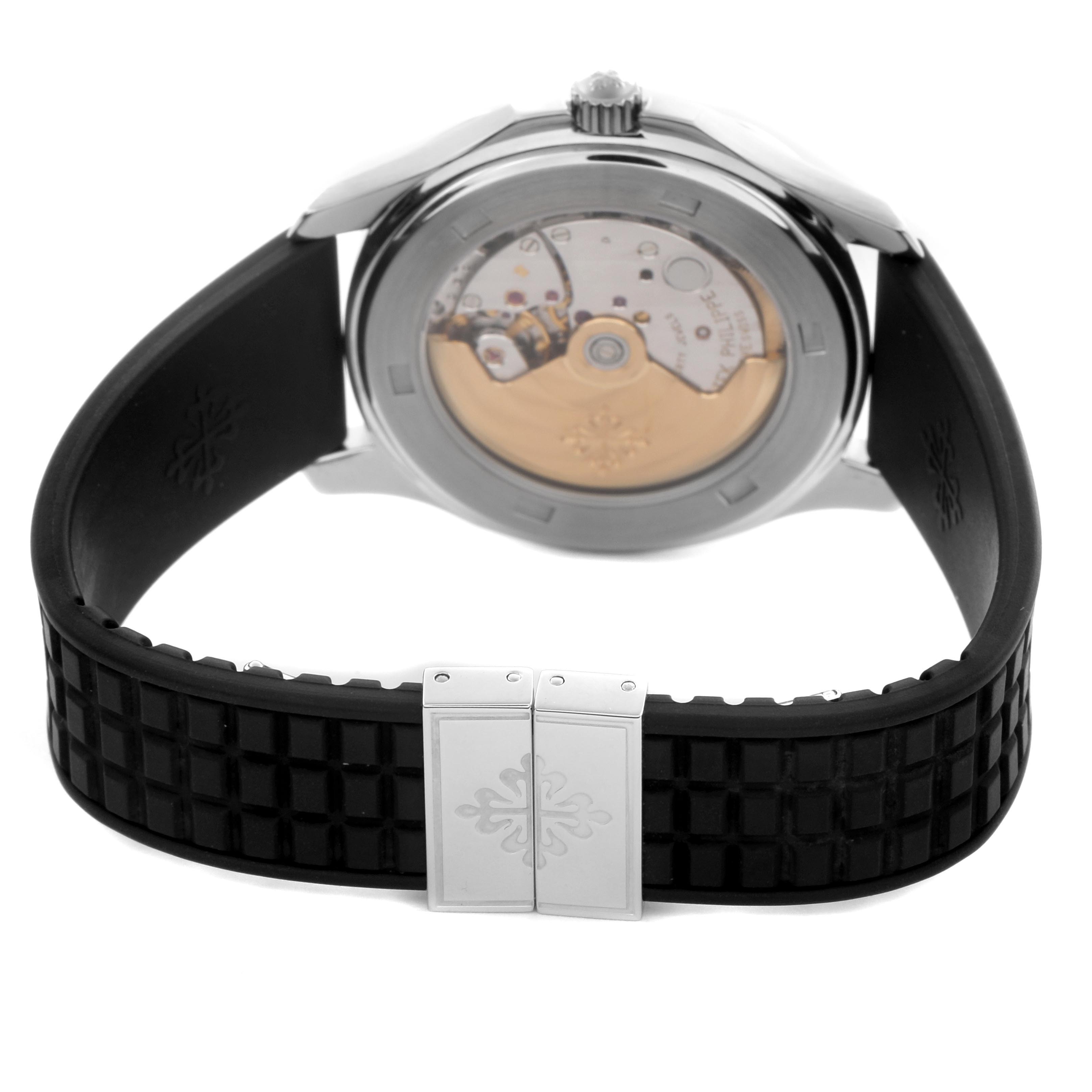 The image shows the back view of the Patek Philippe Aquanaut 5065/1A-001, highlighting the movement through the transparent case back and the clasp on the rubber strap.