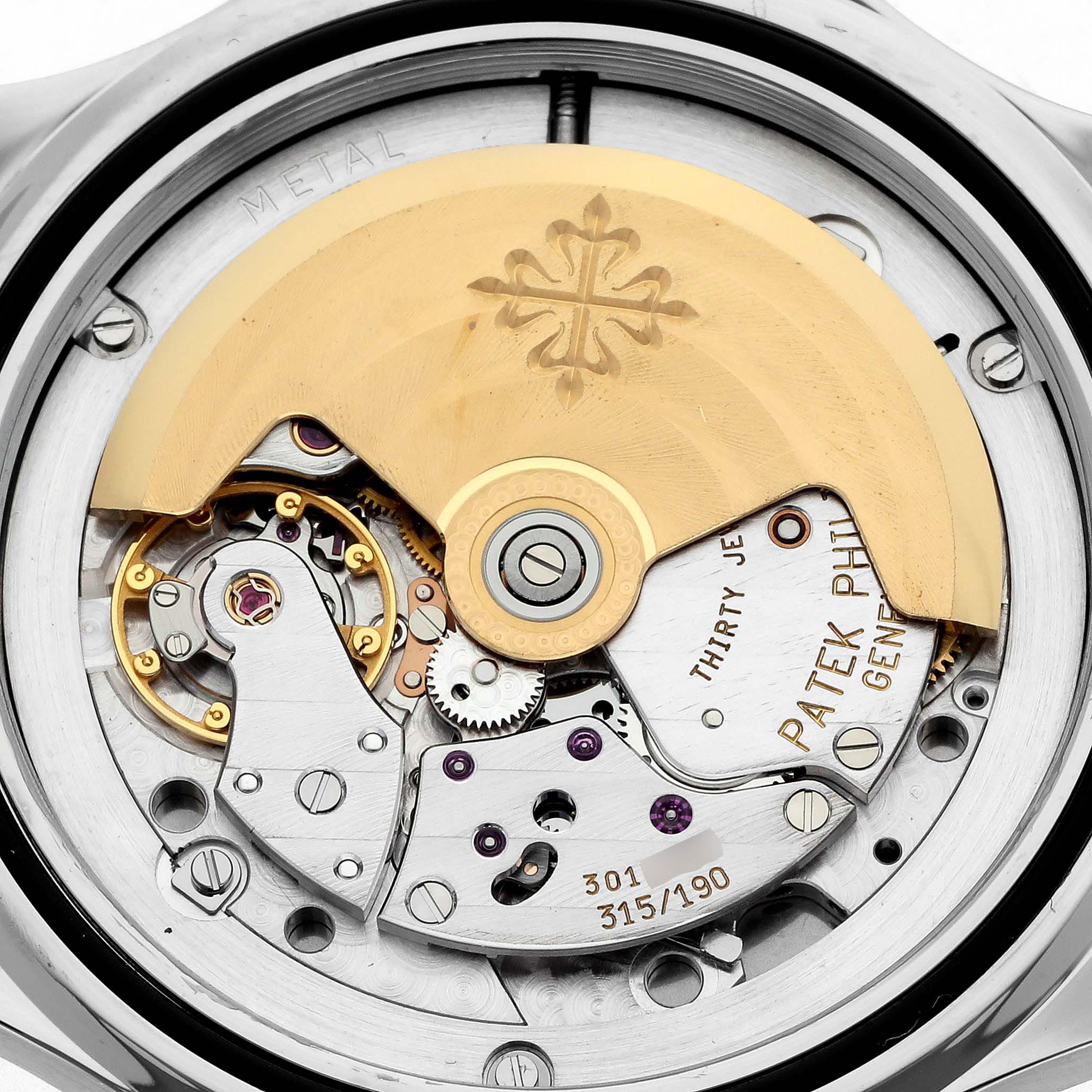 The image shows the movement and rotor of a Patek Philippe Aquanaut model 5065/1A-001, viewed from the back with intricate mechanical details visible.