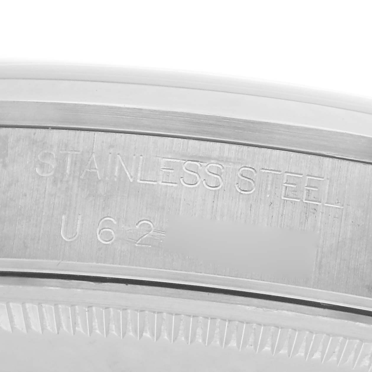 The image shows a close-up of the side of a Rolex Air-King model 14000 watch, highlighting the stainless steel material and serial number engraving.
