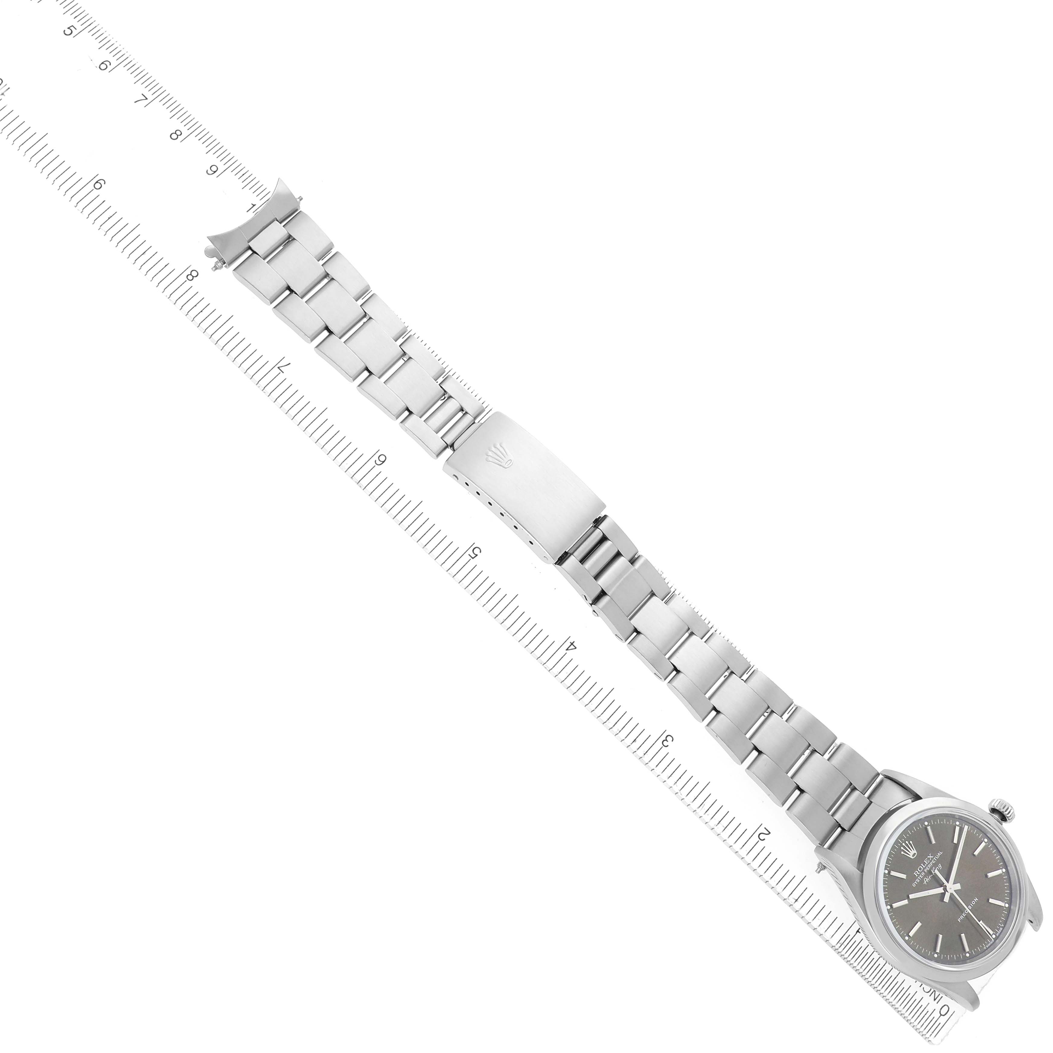 The Rolex Air-King model 14000 watch is displayed from an overhead angle, showing the full length of the bracelet alongside a ruler.