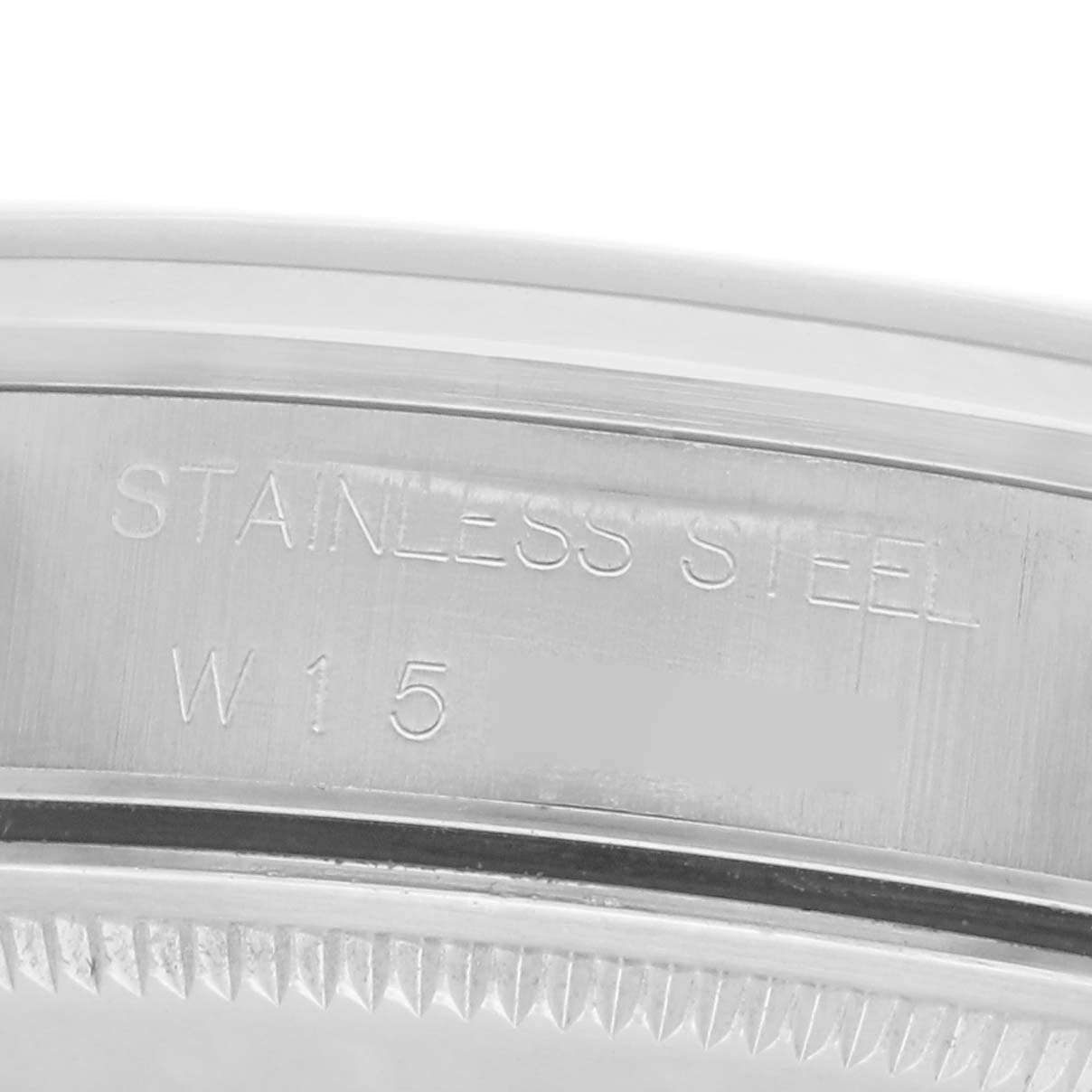The image shows a close-up of the Rolex Air-King model 14000 made of stainless steel, focusing on the engraved inner case and bezel edge.