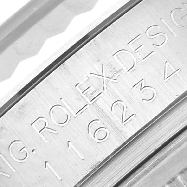 This close-up image shows the engraved serial number and "Rolex Design" inscription on the side of the Rolex Datejust 116234 Men's Stainless Steel Mother of Pearl Dial 116234 Men's Stainless Steel Mother of Pearl Dial model.
