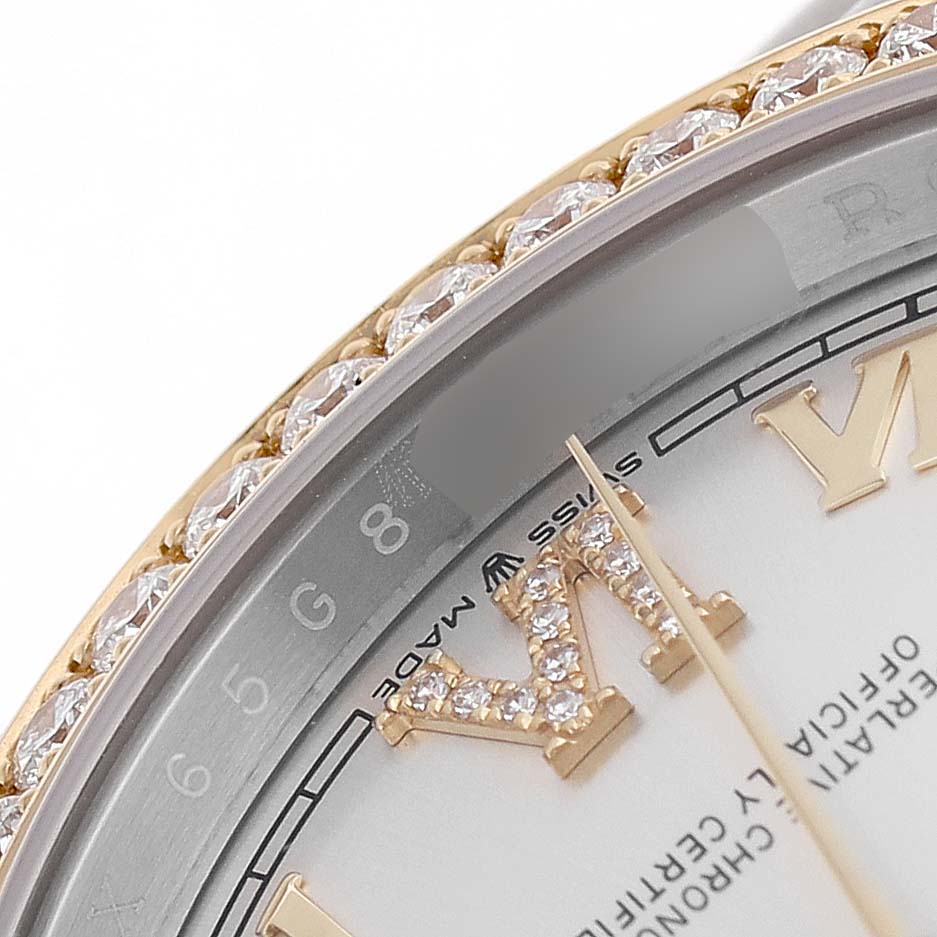 The image shows a close-up of a Rolex Datejust 126283 Men's Steel and Gold (two tone) Silver Dial watch's bezel, diamond-set Roman numeral, and partial dial.