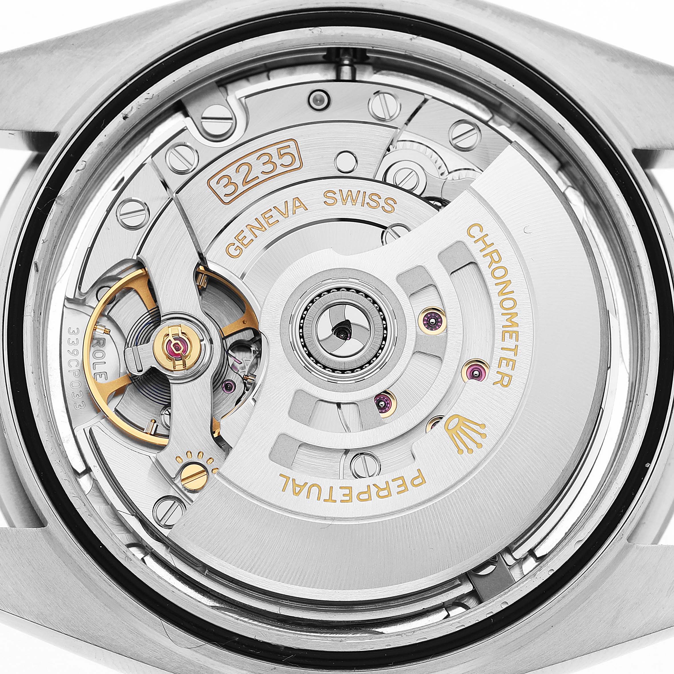 The image shows the movement of a Rolex Datejust 41 126300 Men's Stainless Steel Grey Dial, showcasing gears and the rotor from the back.