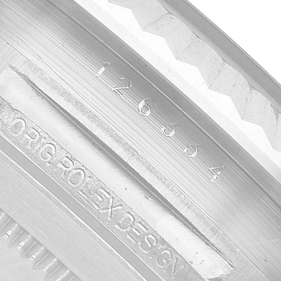 The image shows a close-up of the inner bezel and engravings on the Rolex Datejust 41 126334 Men's Stainless Steel Blue Dial.