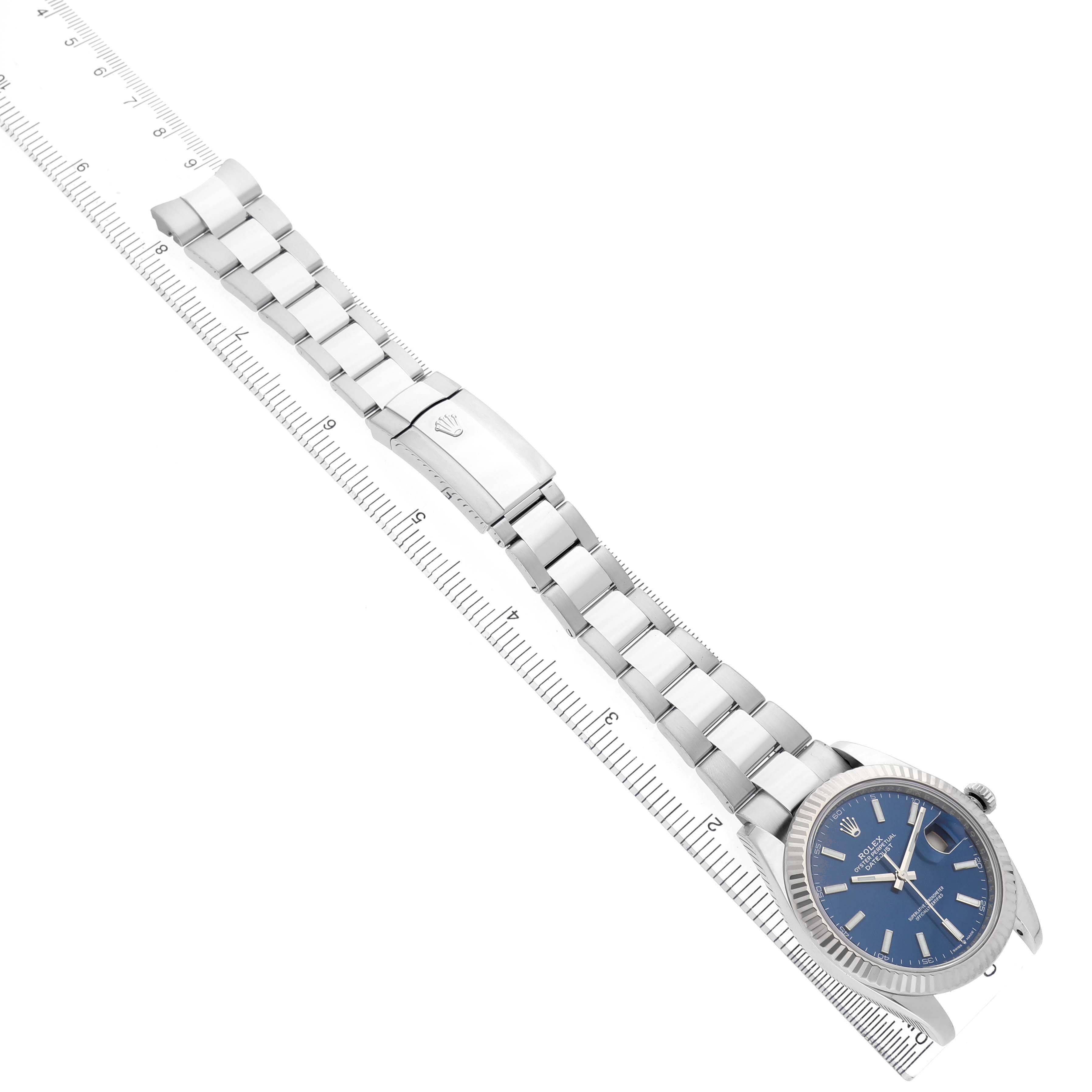 The Rolex Datejust 41 126334 Men's Stainless Steel Blue Dial is displayed at a diagonal angle, showing the full bracelet, clasp, and a blue dial.