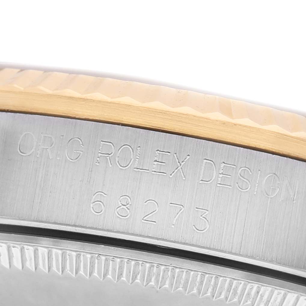 The image shows a close-up of the bezel and case side of a Rolex Datejust 68273 Women's Steel and Gold (two tone) Champagne Dial, highlighting the model number engraving.