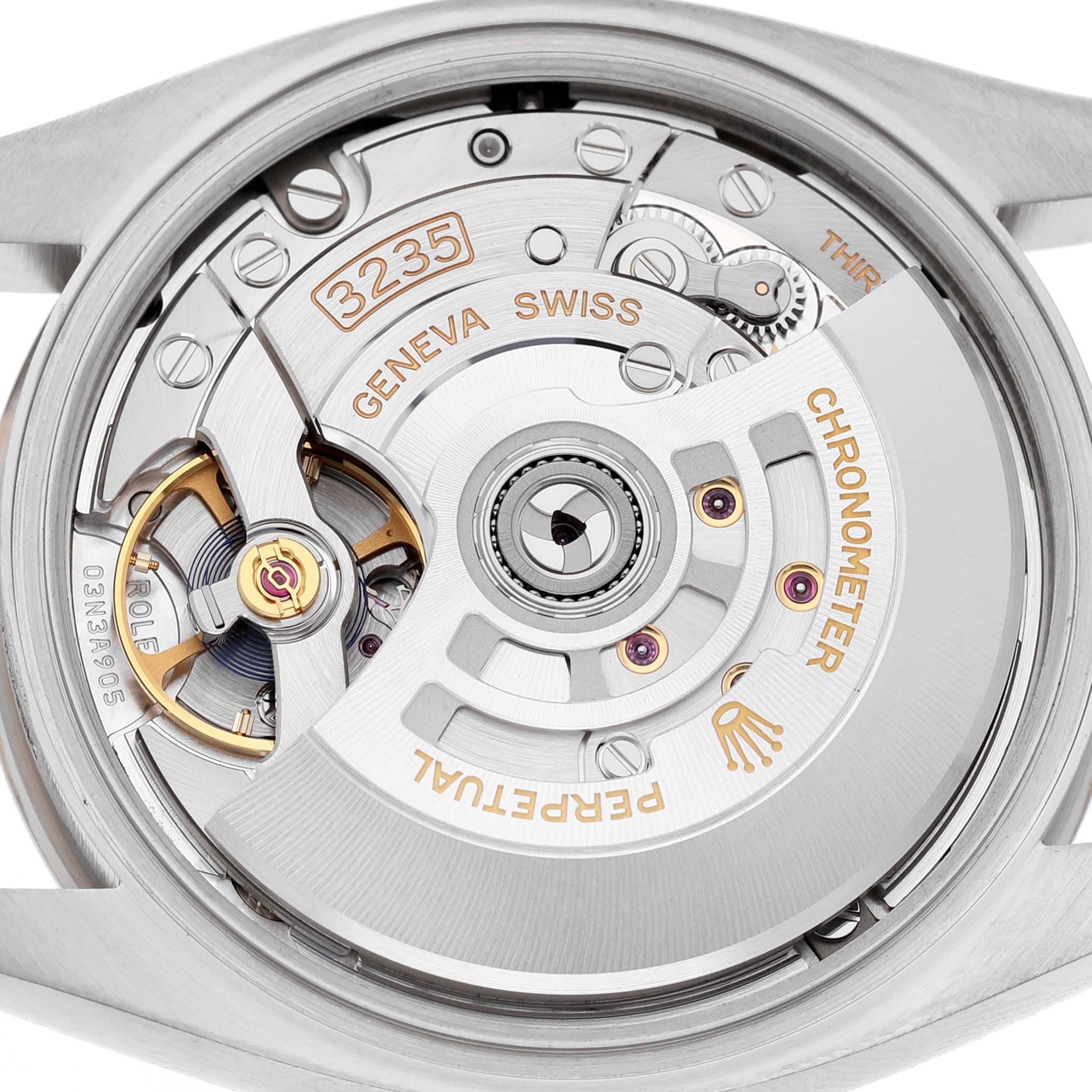 The image shows the movement of a Rolex Datejust 126234 Men's Stainless Steel Green Dial, focusing on its intricate mechanical components from a back view.