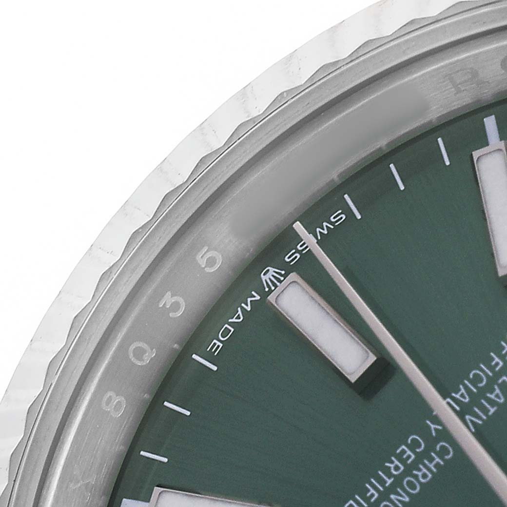 The image shows a close-up of the corner of the dial and bezel of a Rolex Datejust 126234 Men's Stainless Steel Green Dial watch.