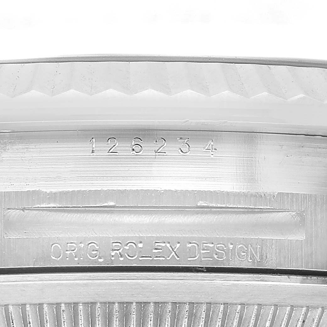 The image shows a close-up of a Rolex Datejust MENS Men's Stainless Steel Silver Dial model's case between the lugs, displaying the engraved model and design numbers.