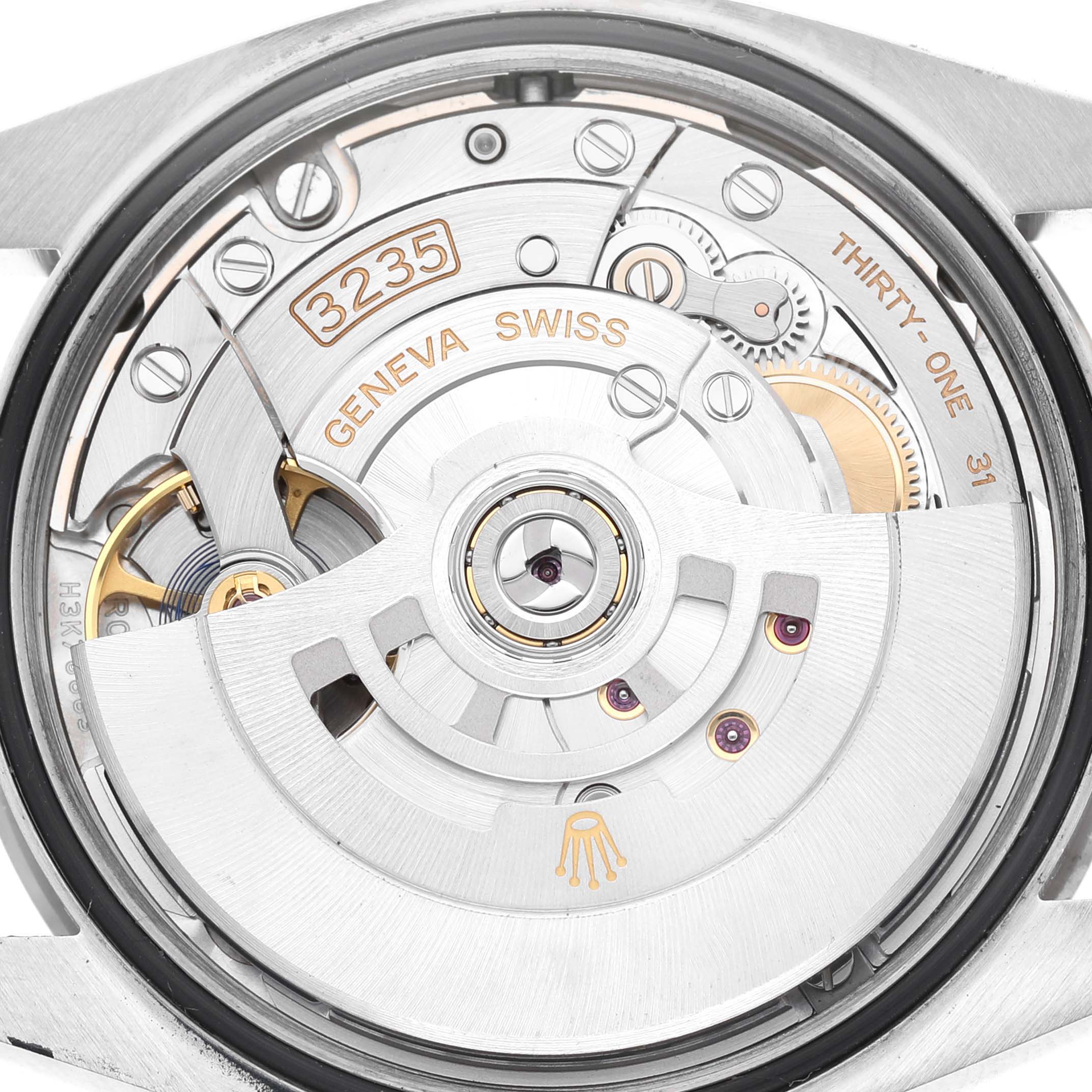 The image shows the movement of the Rolex Datejust MENS Men's Stainless Steel Silver Dial watch from the back, highlighting gears and the oscillating weight.