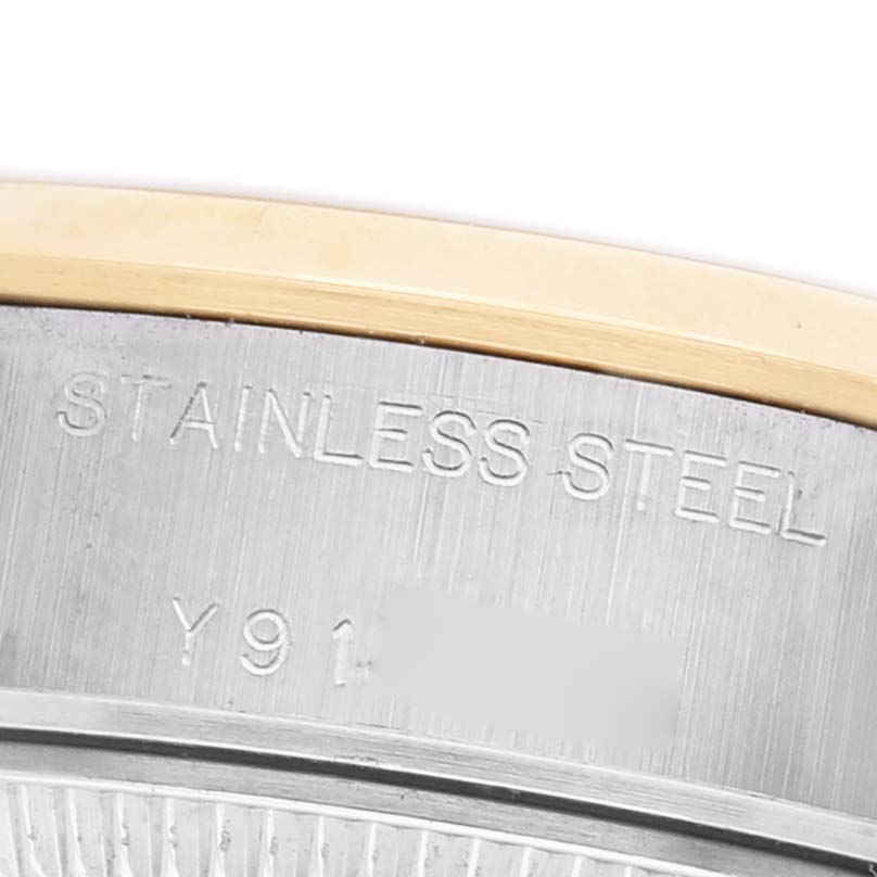 The image shows a close-up of the stainless steel casing and engraved markings on a Rolex Datejust 79163 Men's Steel and Gold (two tone) Champagne Dial watch.