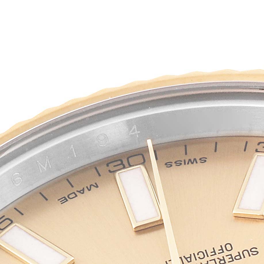 The image shows a close-up of the dial and part of the bezel of a Rolex Datejust 116333 Men
s Steel and Gold (two tone) Champagne Dial 116333 Men
s Steel and Gold (two tone) Champagne Dial watch, focusing on the indices and text.