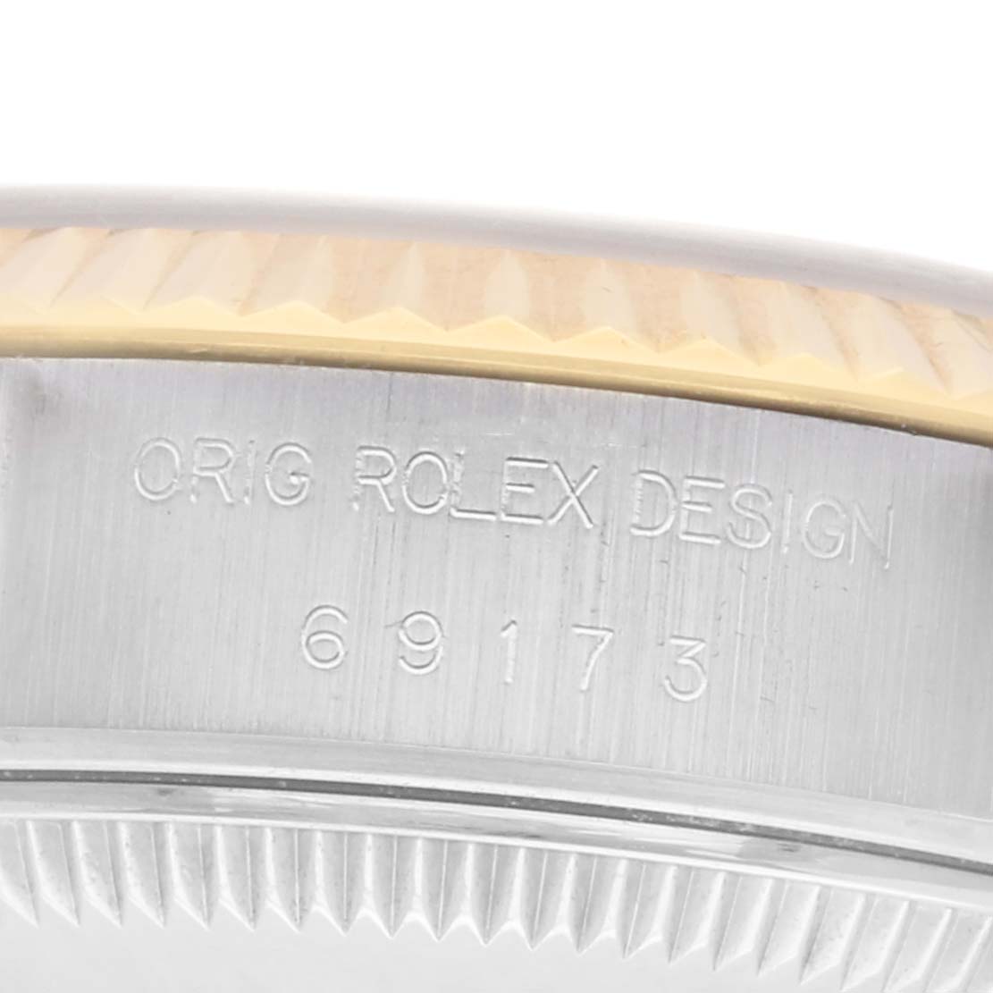 The image shows a close-up of the side of the Rolex Datejust model 69173, focusing on the bezel and engraved case details.