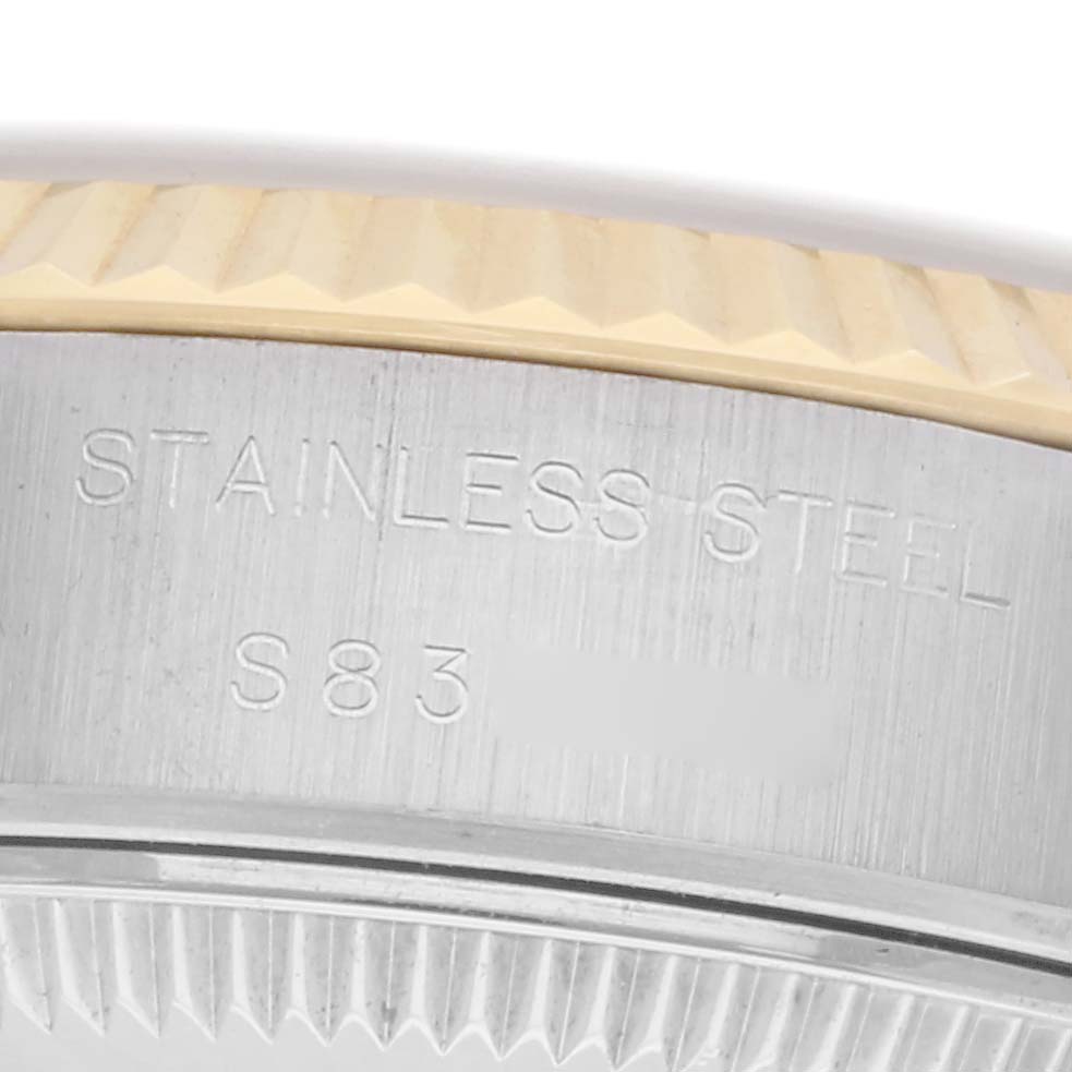 The image shows a close-up of the edge and side of the case of the Rolex Datejust model 69173, displaying the "STAINLESS STEEL" engraving.