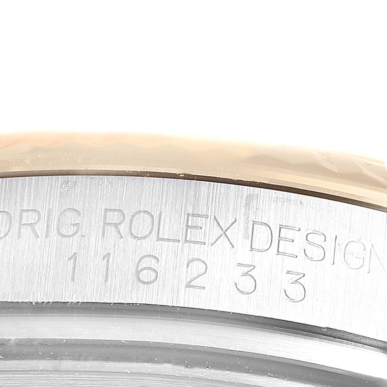 The image shows a close-up of the case side of a Rolex Datejust 116233 Men's Steel and Gold (two tone) Silver Dial 116233 Men's Steel and Gold (two tone) Silver Dial, displaying the model number and "ORIG ROLEX DESIGN" engraving.