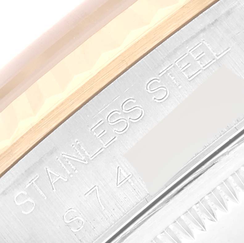 This image shows a close-up of the case side and markings of the Rolex Datejust 16233 Men's Steel and Gold (two tone) Champagne Dial 16233 Men's Steel and Gold (two tone) Champagne Dial watch, highlighting the "STAINLESS STEEL" engraving.