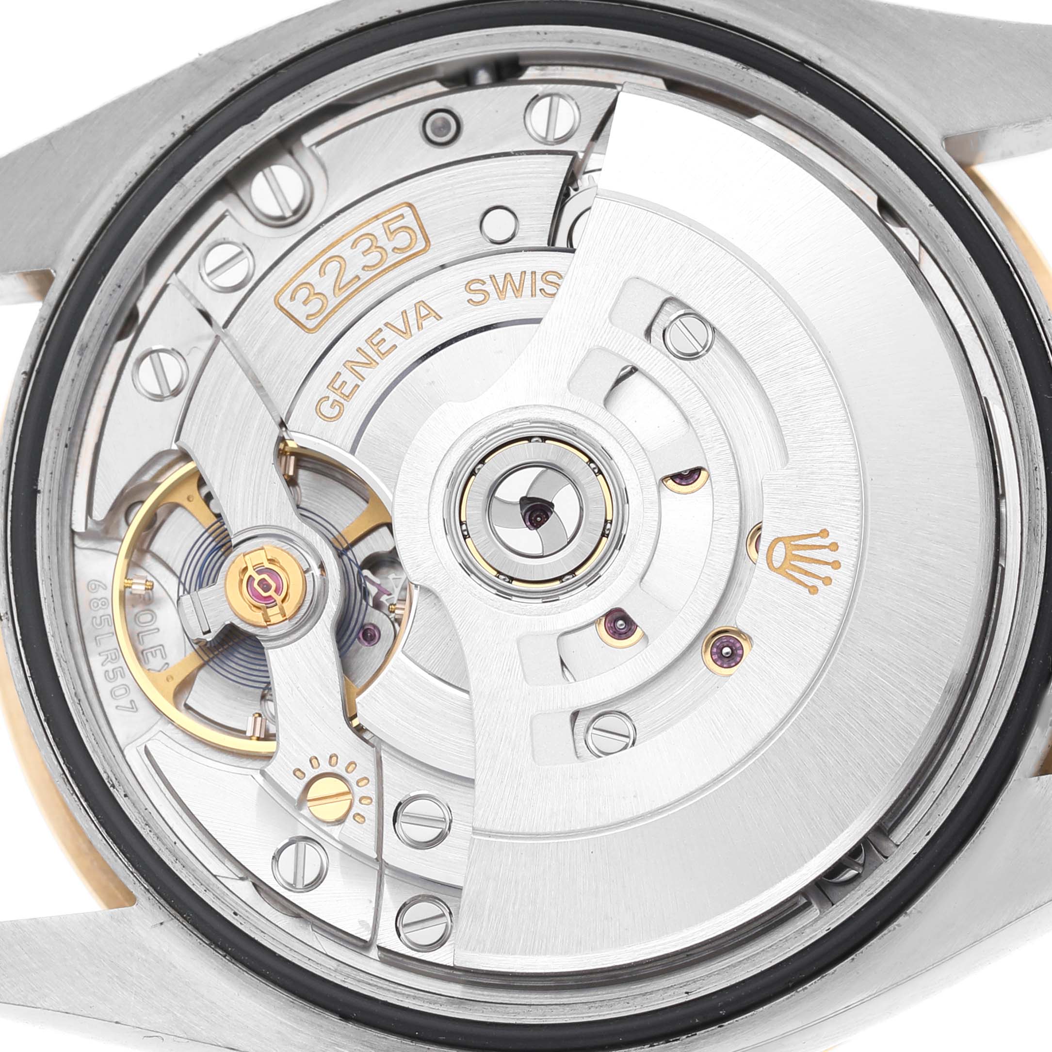 This image shows the movement of a Rolex Datejust 126283 Men's Steel and Gold (two tone) Mother of Pearl Dial, highlighting the rotor and intricate mechanics from the back angle.