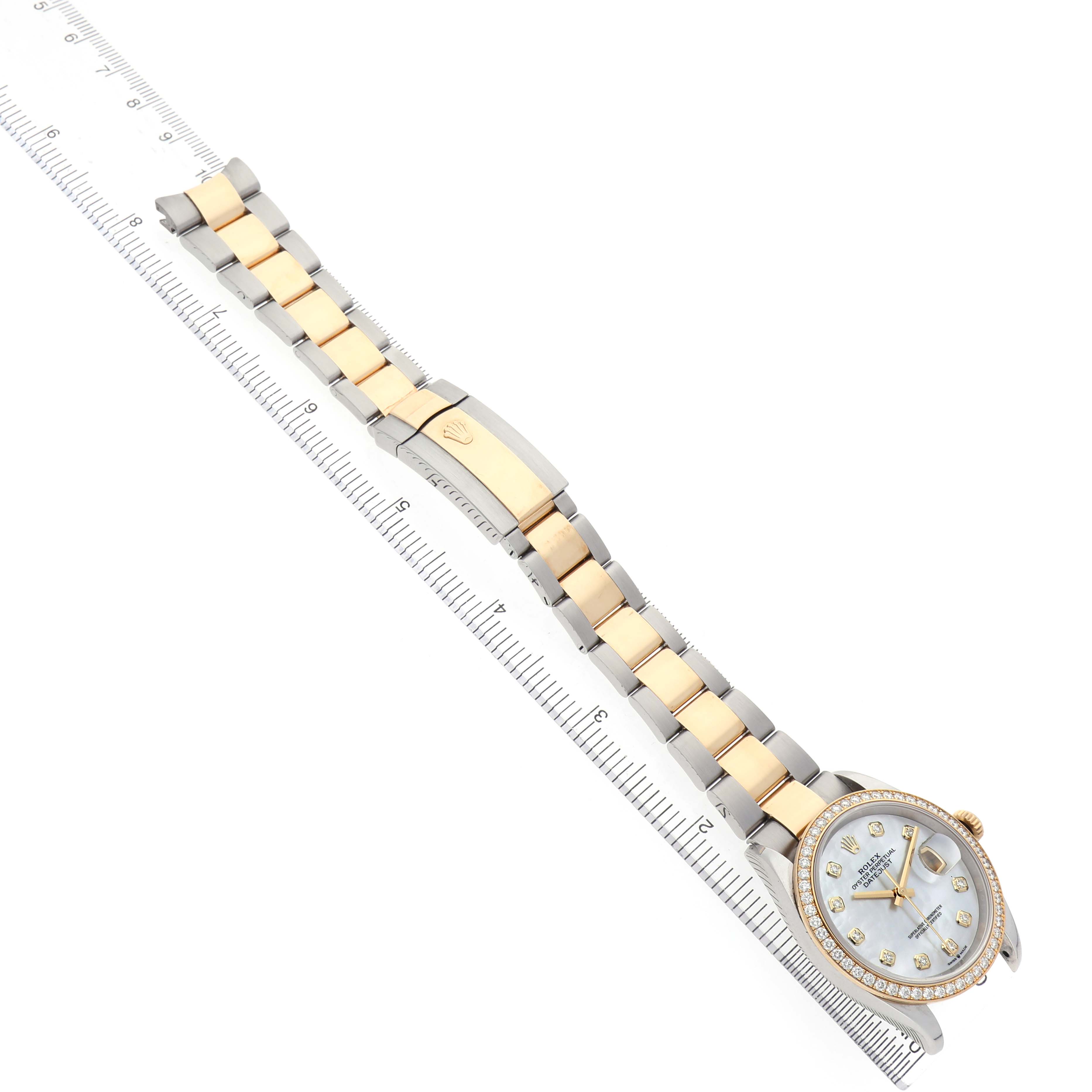 The image shows a Rolex Datejust 126283 Men's Steel and Gold (two tone) Mother of Pearl Dial watch laid flat at a slight angle, highlighting the dial, bezel, and two-tone bracelet.