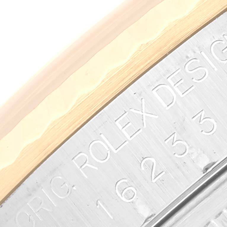 This image shows a close-up of the Rolex Datejust 16233 Men's Steel and Gold (two tone) Grey Dial 16233 Men's Steel and Gold (two tone) Grey Dial model with part of the bezel and the engraved text on the watch's side.