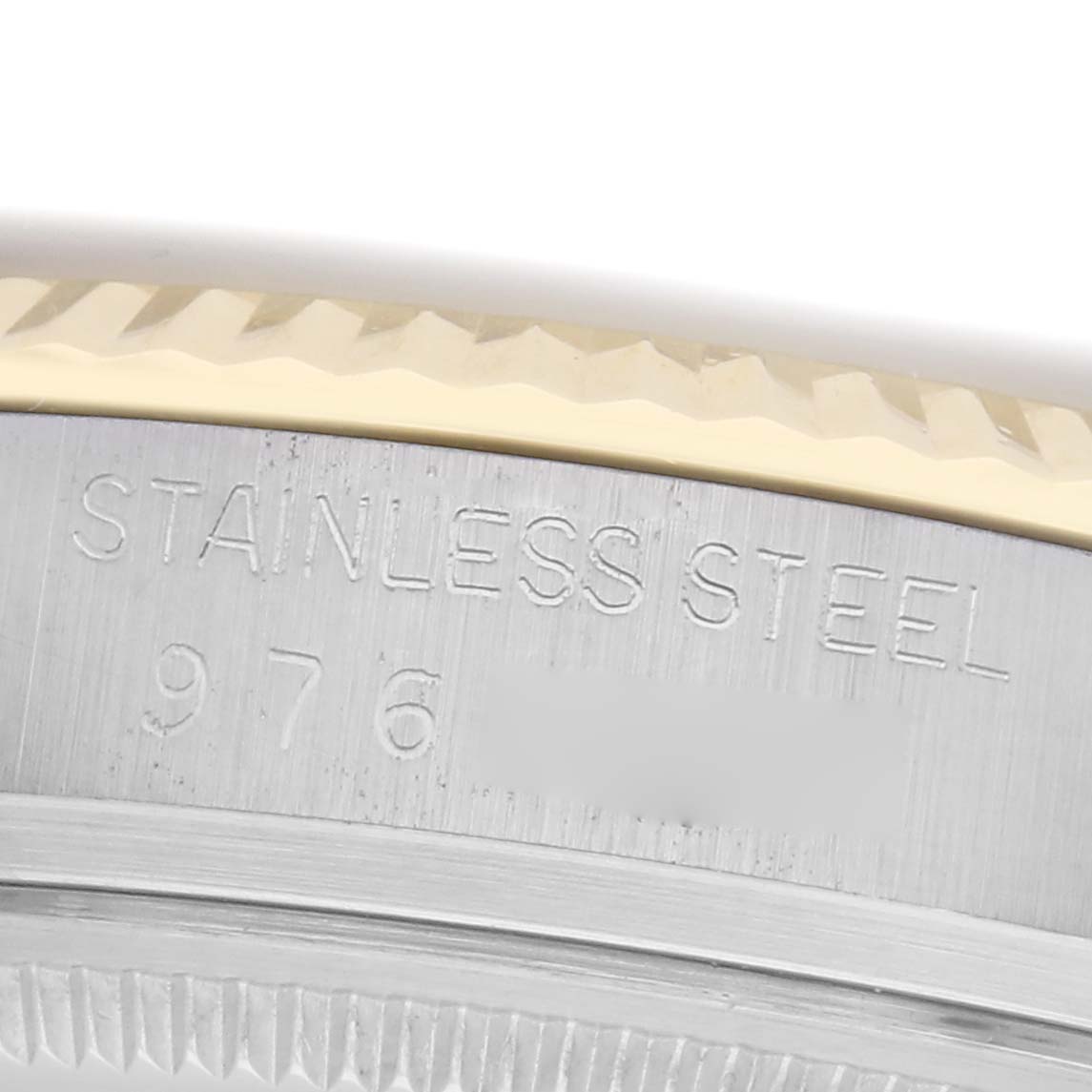 The image shows a close-up of the edge of the Rolex Datejust model 16013 watch case, highlighting the stainless steel marking and part of the fluted bezel.