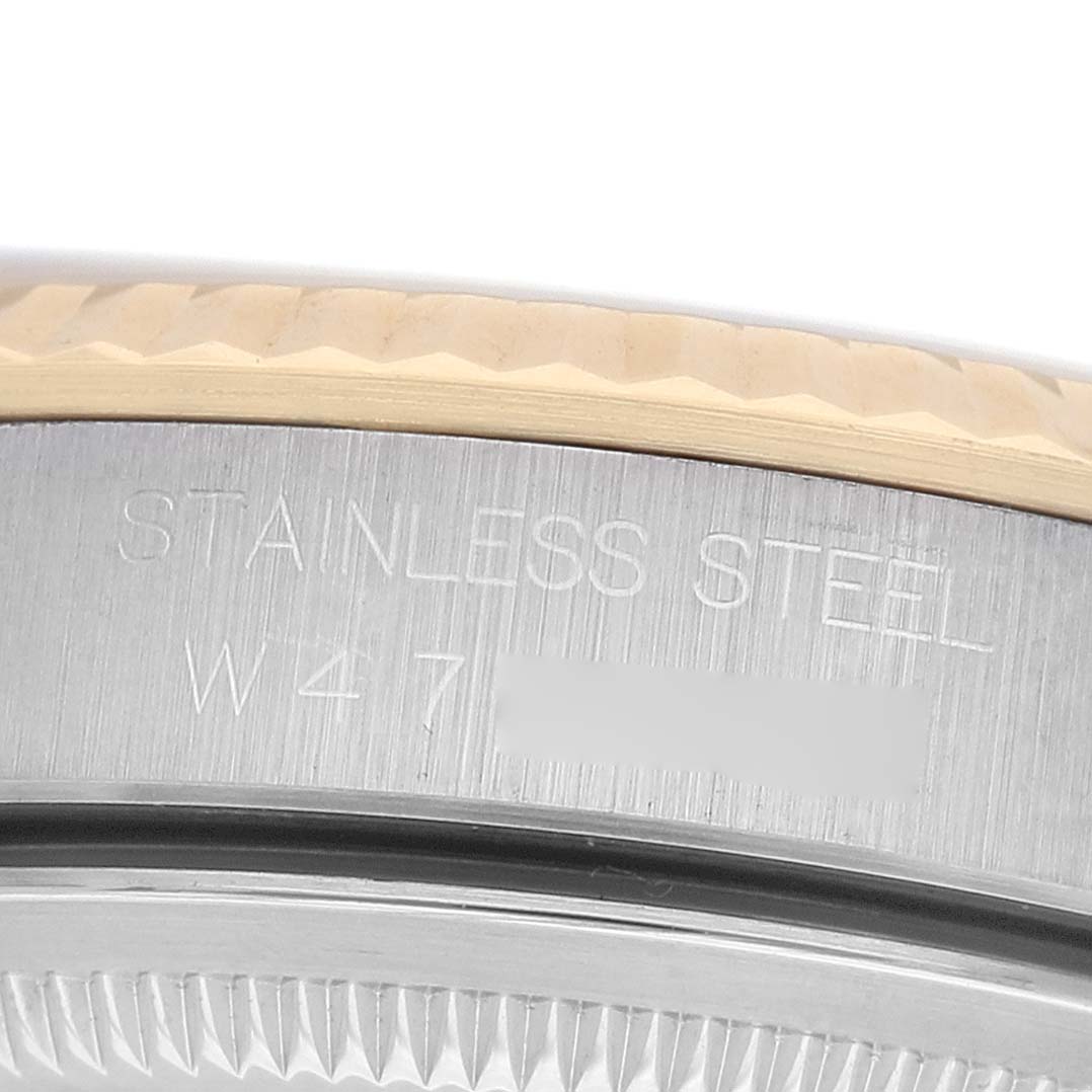 The image shows a close-up of the side of a Rolex Datejust 16233 Men's Steel and Gold (two tone) White Dial watch case, focusing on the engraved words "Stainless Steel."