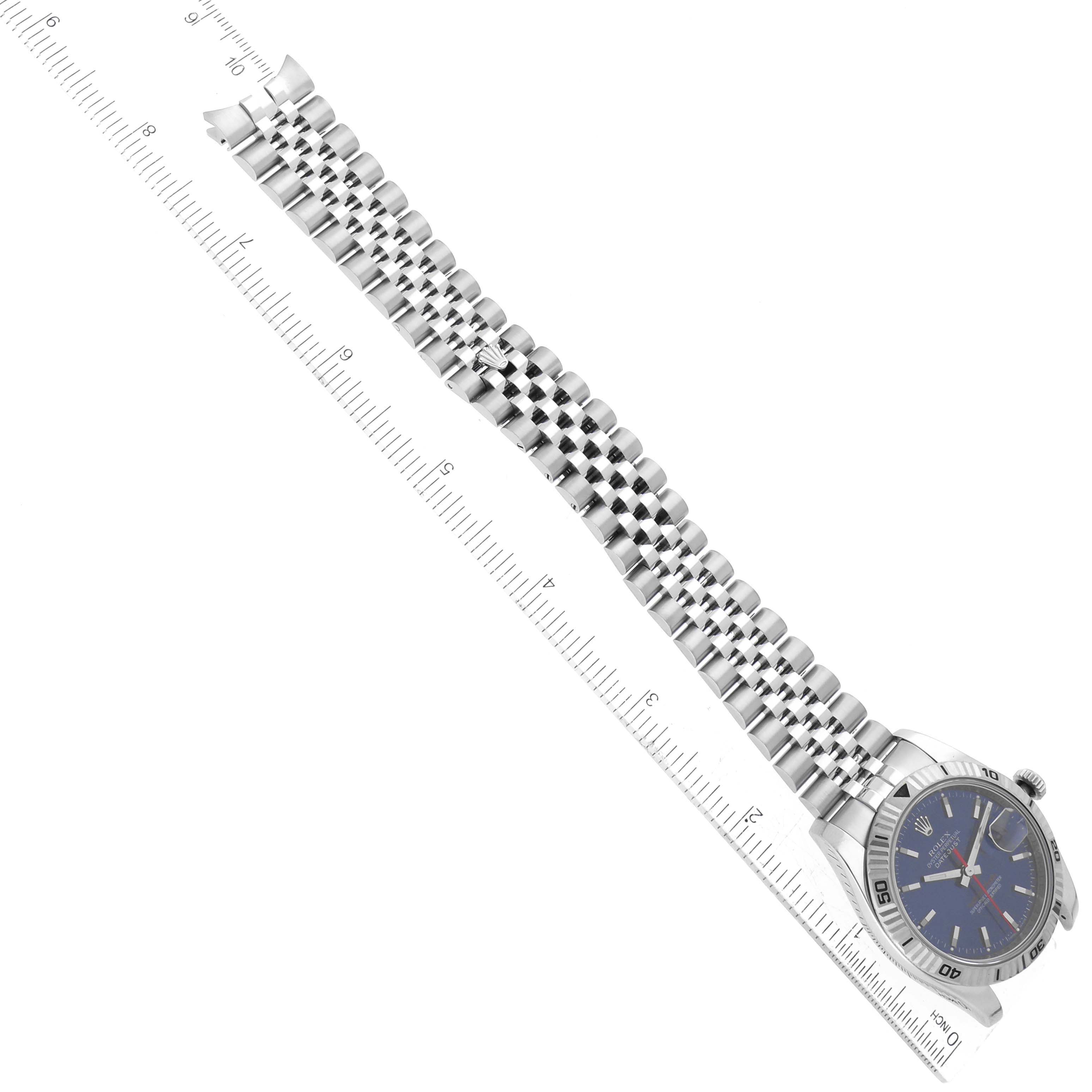 The image shows a Rolex Turn-o-Graph 116264 Men's Stainless Steel Blue Dial 116264 Men's Stainless Steel Blue Dial watch with a full view of its face and bracelet laid against a ruler.