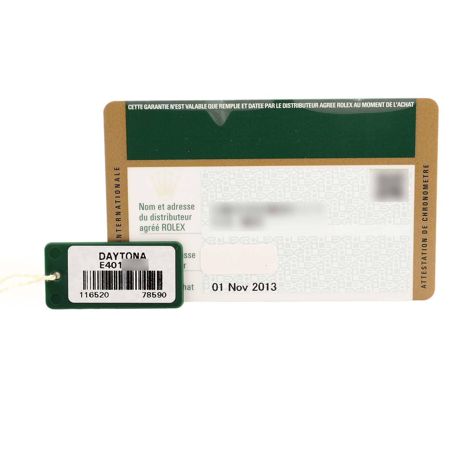 The image shows a Rolex Daytona 116520 Men's Stainless Steel Black Dial warranty card and a green tag.