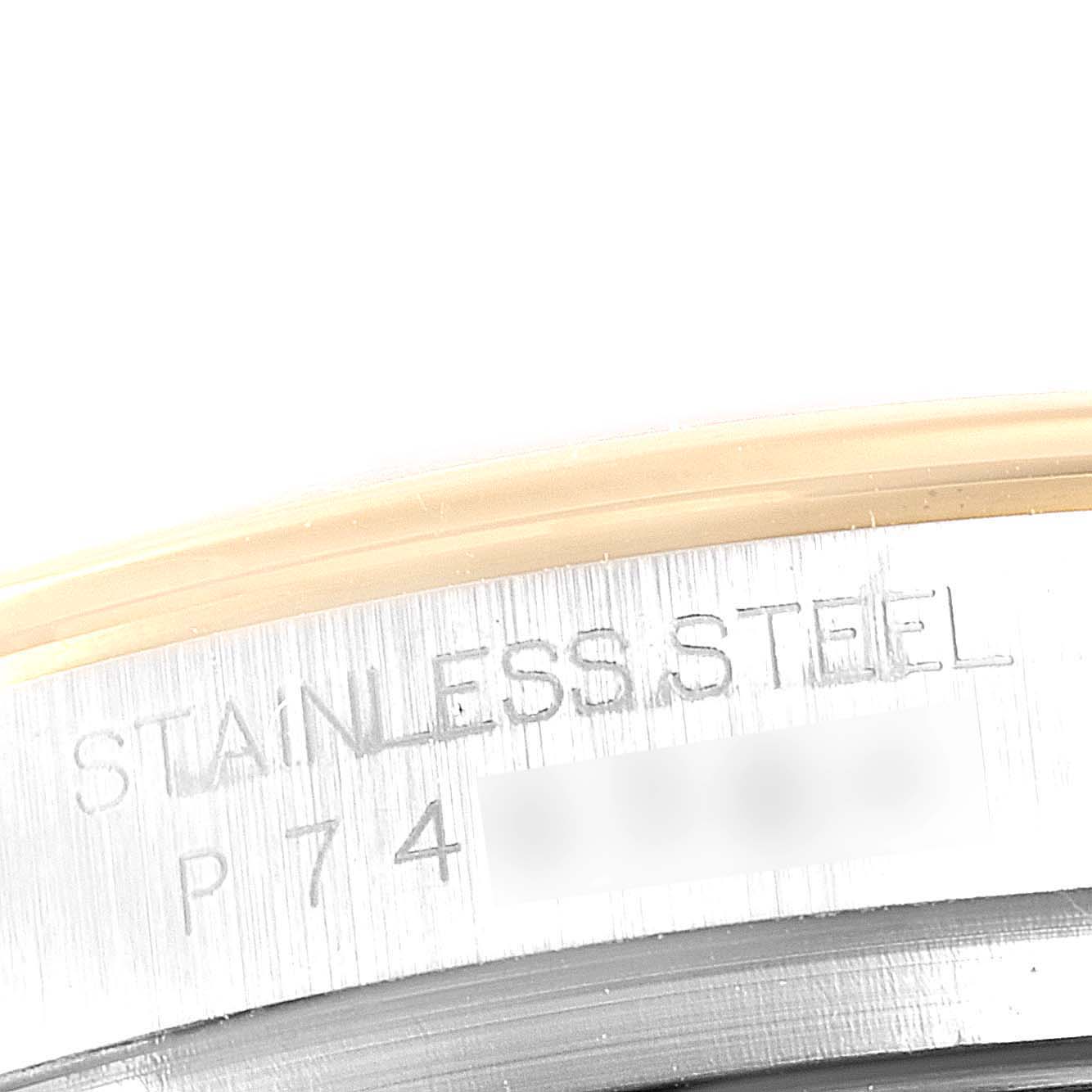 This close-up shows the engraving on the case back of a Rolex Daytona 116523 Men
s Steel and Gold (two tone) Black Dial 116523 Men
s Steel and Gold (two tone) Black Dial watch, highlighting "STAINLESS STEEL" and a partial serial number.