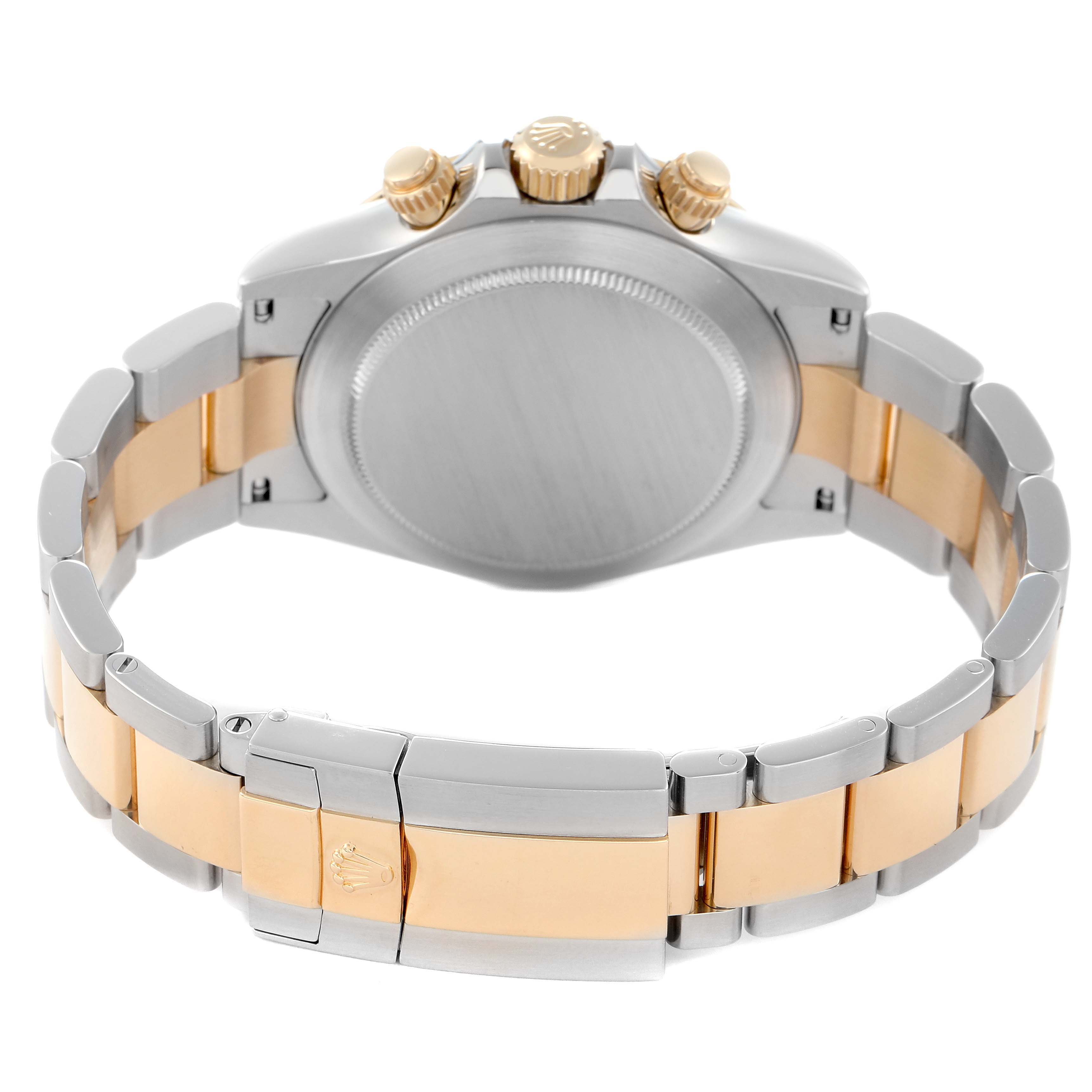 The image shows the back view of a Rolex Daytona model 116523 men's watch, highlighting the caseback, crown, and two-tone bracelet.