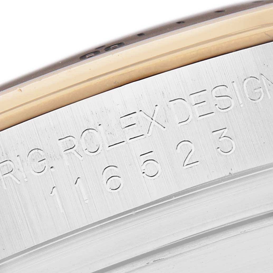 The image shows a close-up of the side of a Rolex Daytona model 116523 watch, highlighting its engraved model number.
