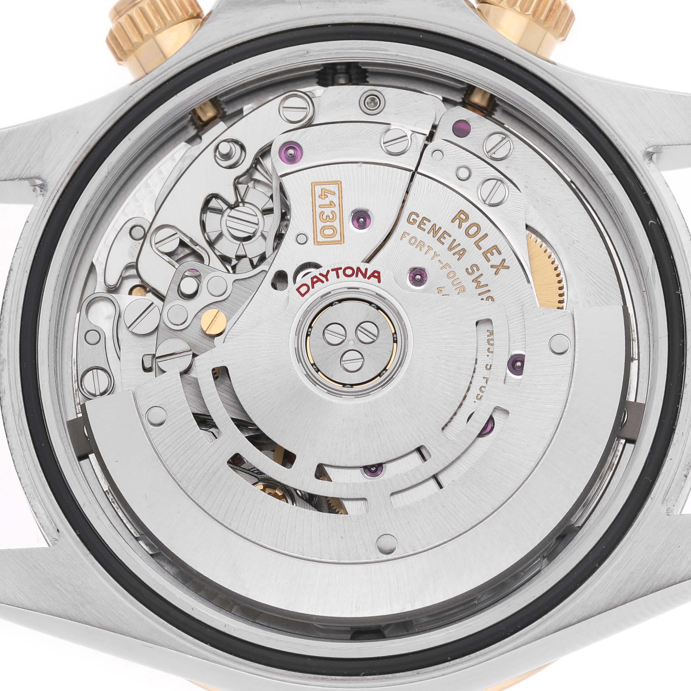 The image shows the back view of a Rolex Daytona 116523 Men's Steel and Gold (two tone) Black Dial, displaying its intricate movement and internal mechanisms.