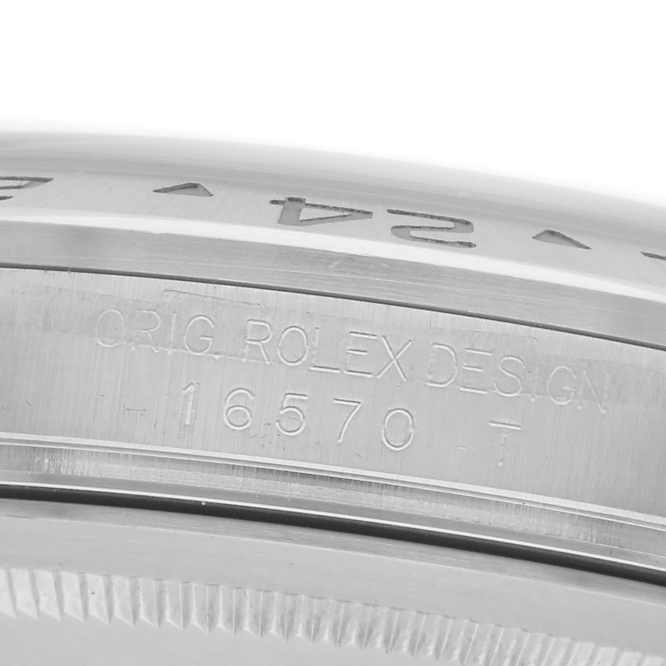 The image shows a close-up of the side of a Rolex Explorer model 216570, featuring engraved text and part of the bezel.