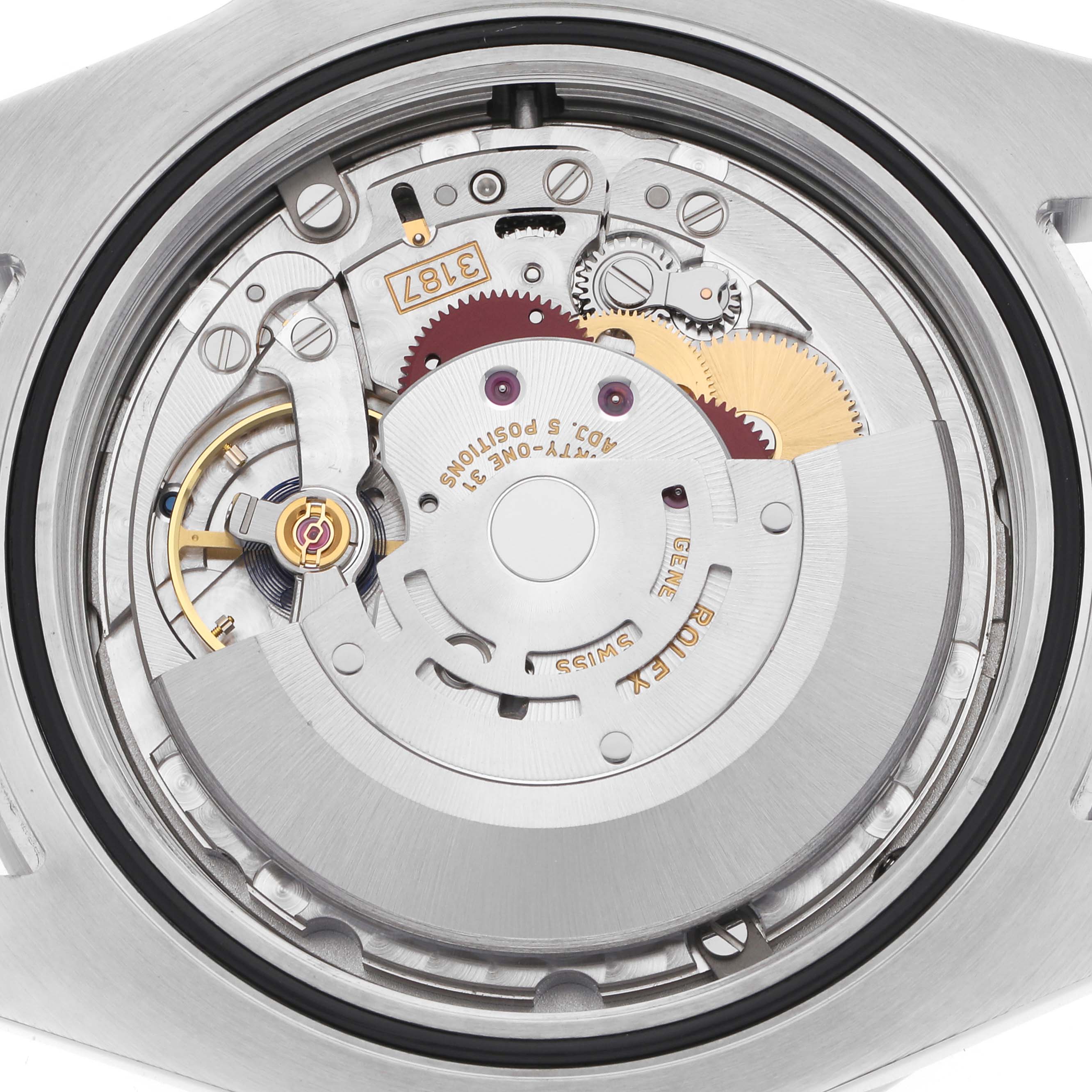 The image shows the back view of a Rolex Explorer model 216570, highlighting the intricate movement and gears inside the watch.