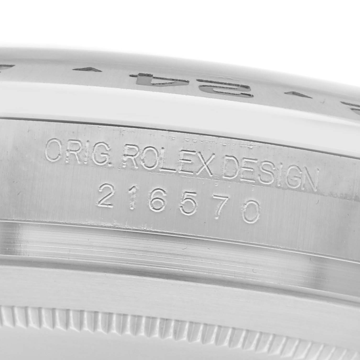 The image shows the engraved side of the bezel of a Rolex Explorer model 216570 men's watch, displaying "ORIG. ROLEX DESIGN" and the model number.