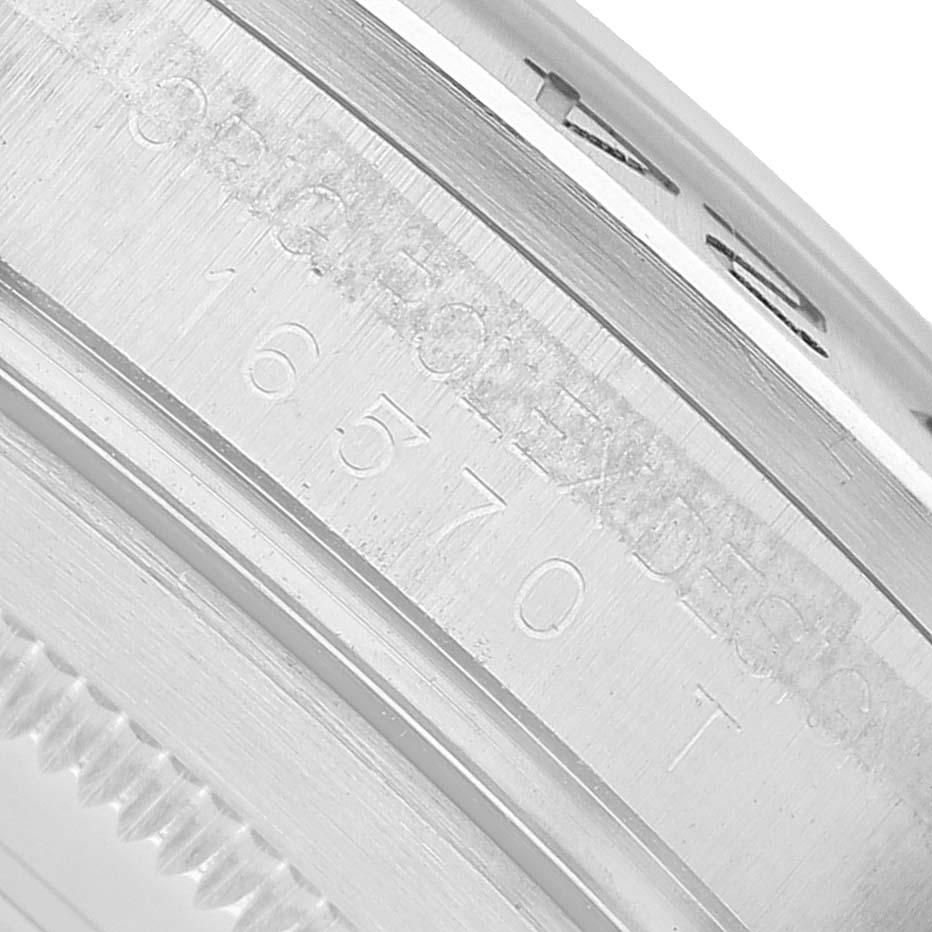 The image shows a close-up of the side view of a Rolex Explorer 16570 T Men's Stainless Steel White Dial watch, focusing on the engraved case details.
